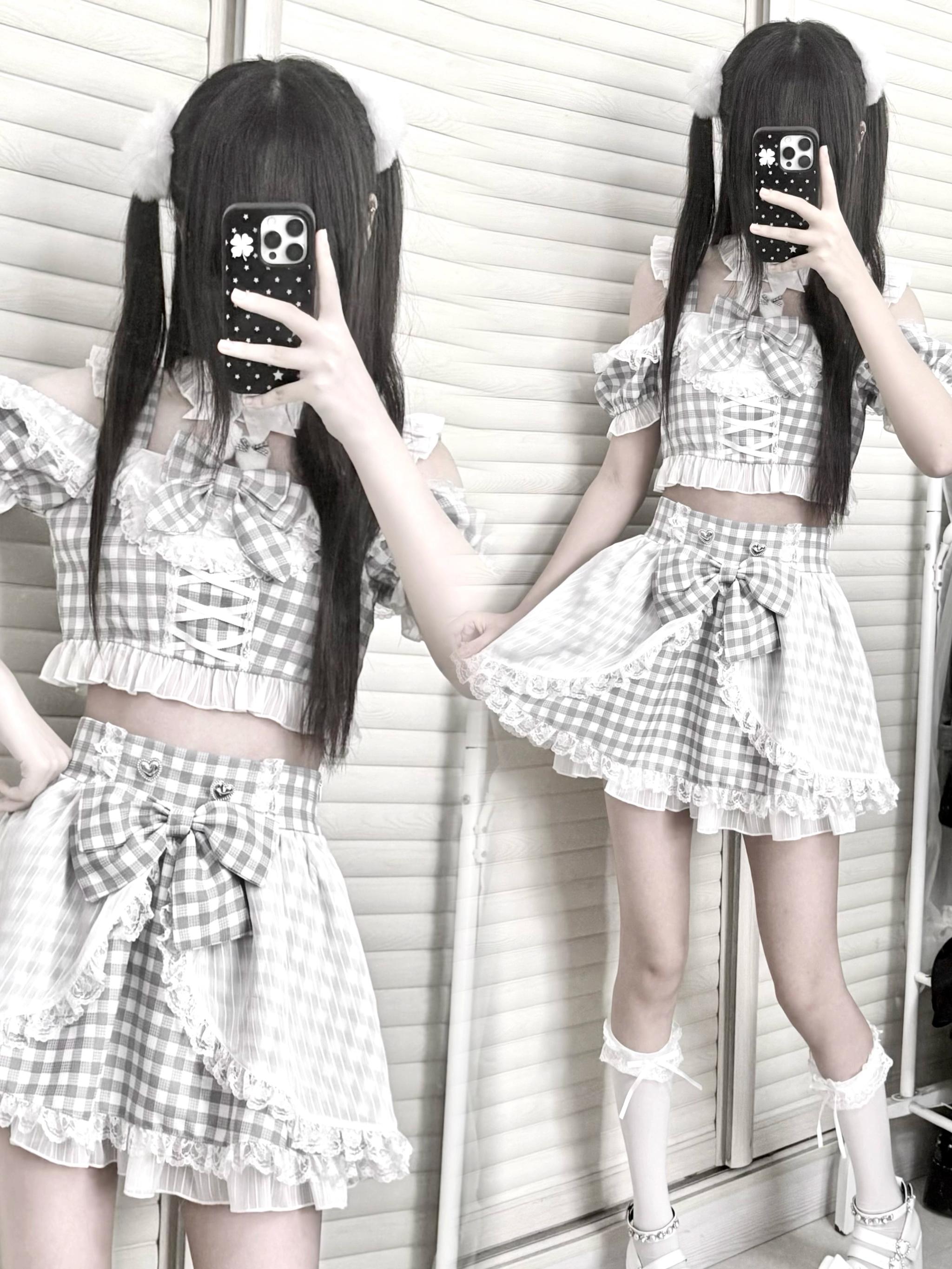 White gingham jirai kei plaid maid outfit on mannequin with white lace hem ruffled sleeves and gingham bow decoration