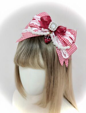 Red and white gingham ryousangata bow hairband with pearl trim and strawberry pendant on mannequin with blonde wig front view