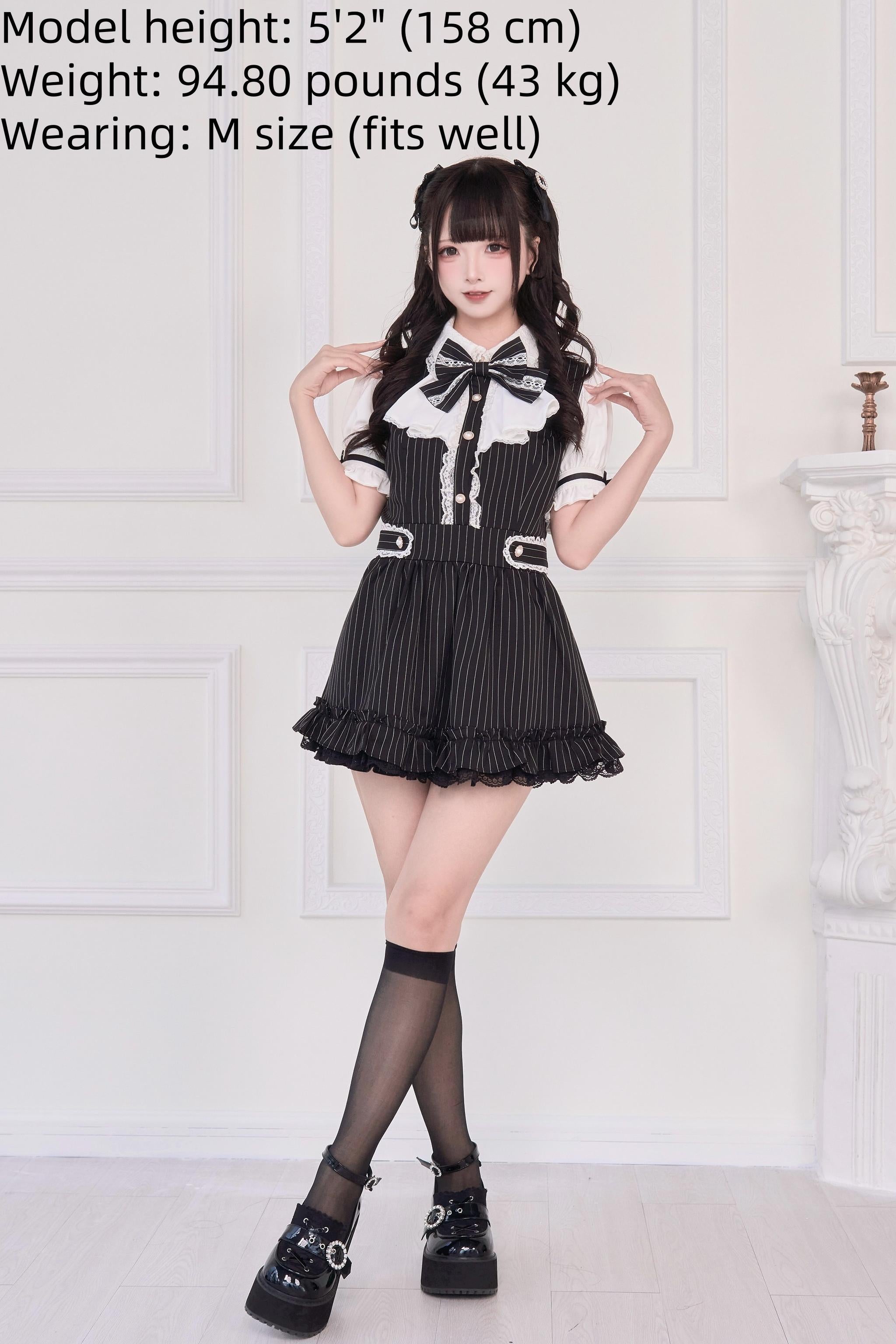 Black striped Jirai Kei dress three-quarter front view model knee socks platform loafers indoor setting