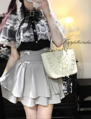 Black pinstripe Jirai Kei ruffle skirt with white vertical stripes, mini bow accents, and built-in shorts, worn by female model in indoor setting showcasing side-back view