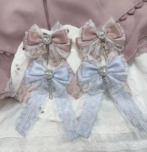 Water Blue Ryousangata lace bow hair clips with crystal heart cross pendant in overhead flat lay, featuring satin ribbon and delicate lace trim on lace textile background