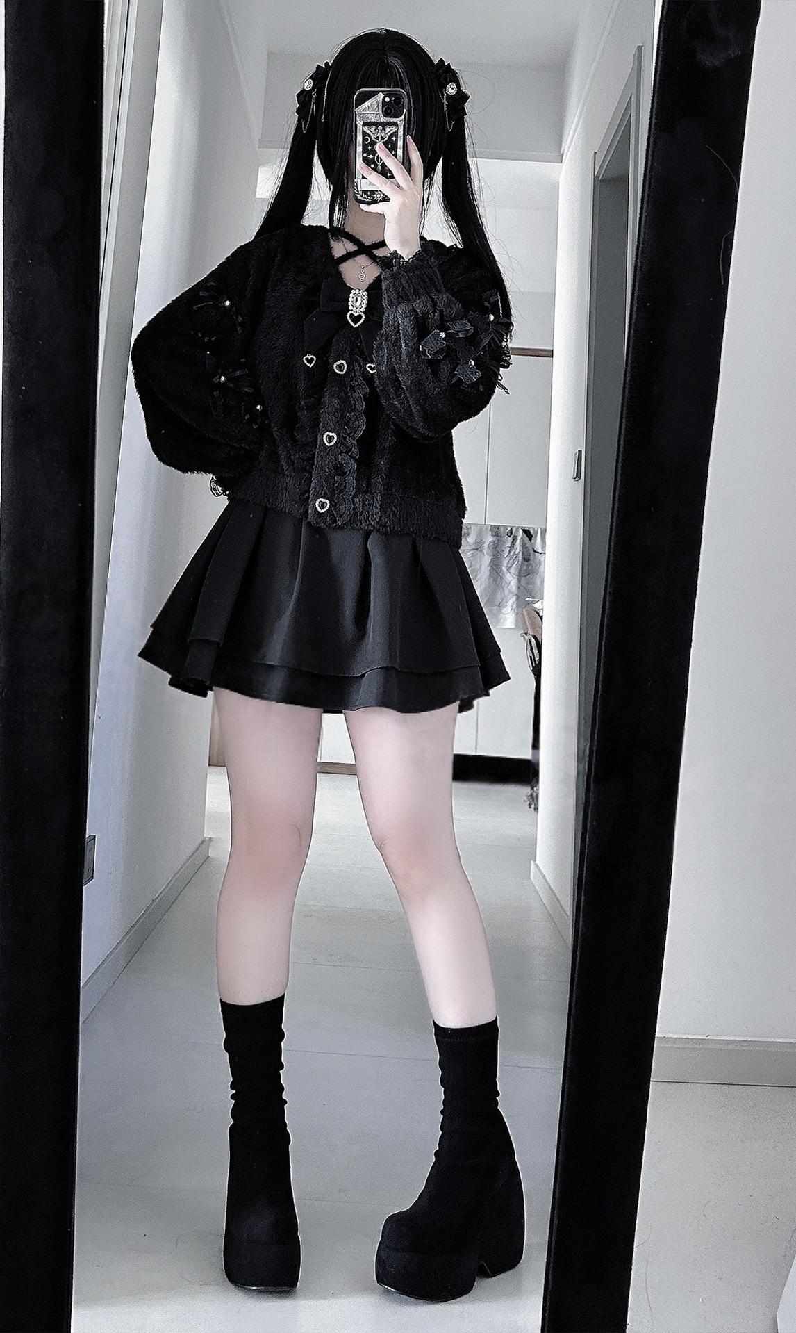 Full-length mirror selfie of black Jirai Kei cardigan set with pleated satin skirt, platform boots, and dramatic alternative aesthetic in home corridor