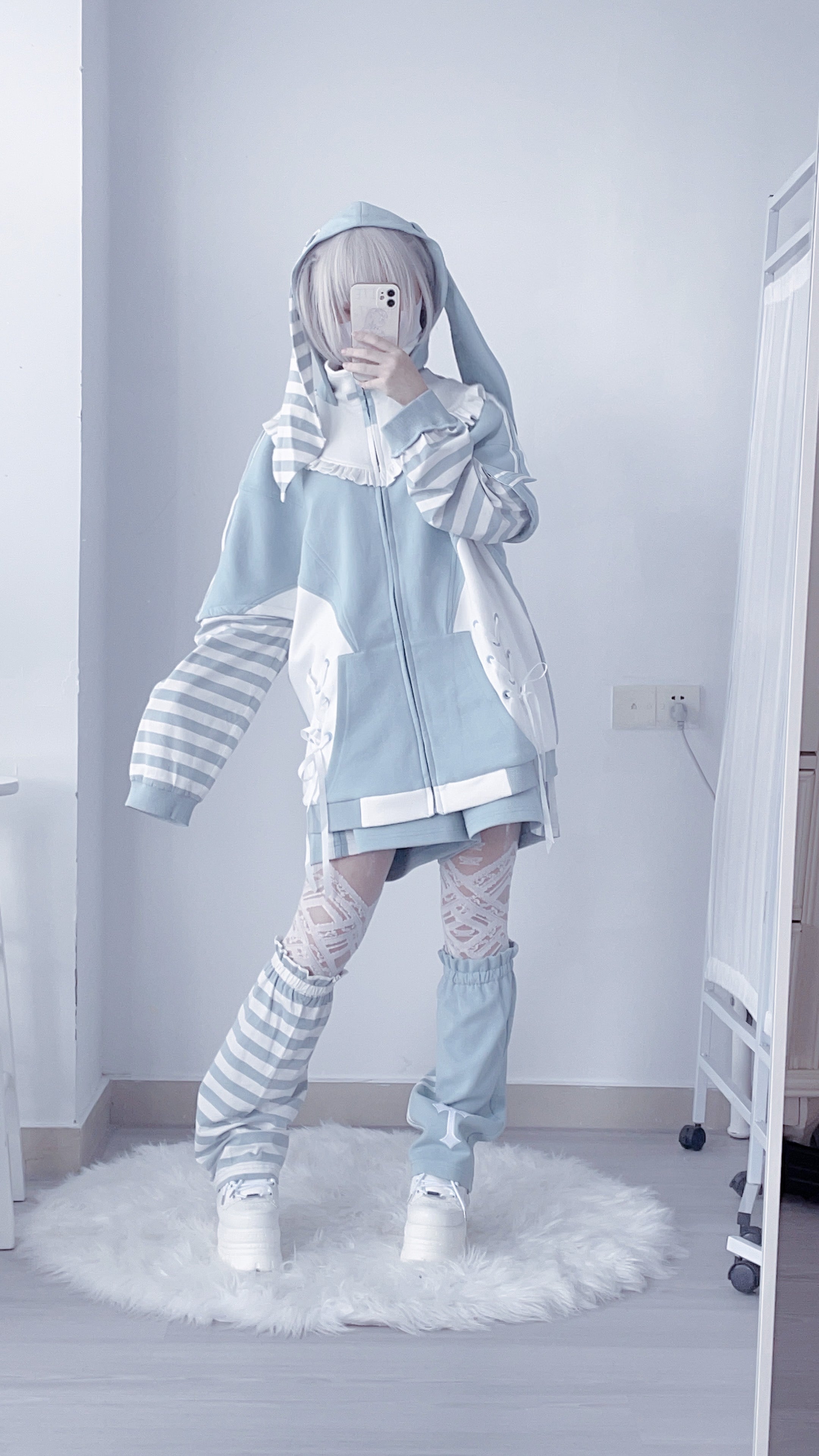Blue Tenshi Kaiwai hoodie with detachable striped sleeves styled as standalone garment showing modular design flexibility