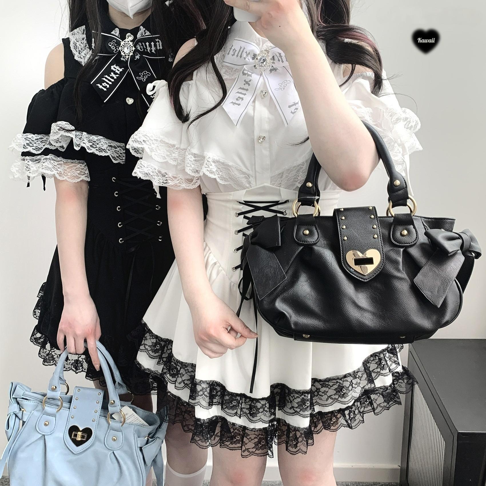White Jirai Kei lace off-shoulder blouse with adjustable straps and heart buttons flat lay product photography