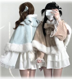 Back view of cat-ear hooded cape on two models wearing lolita dresses, showing khaki and light blue variants with bow details and fuzzy hem