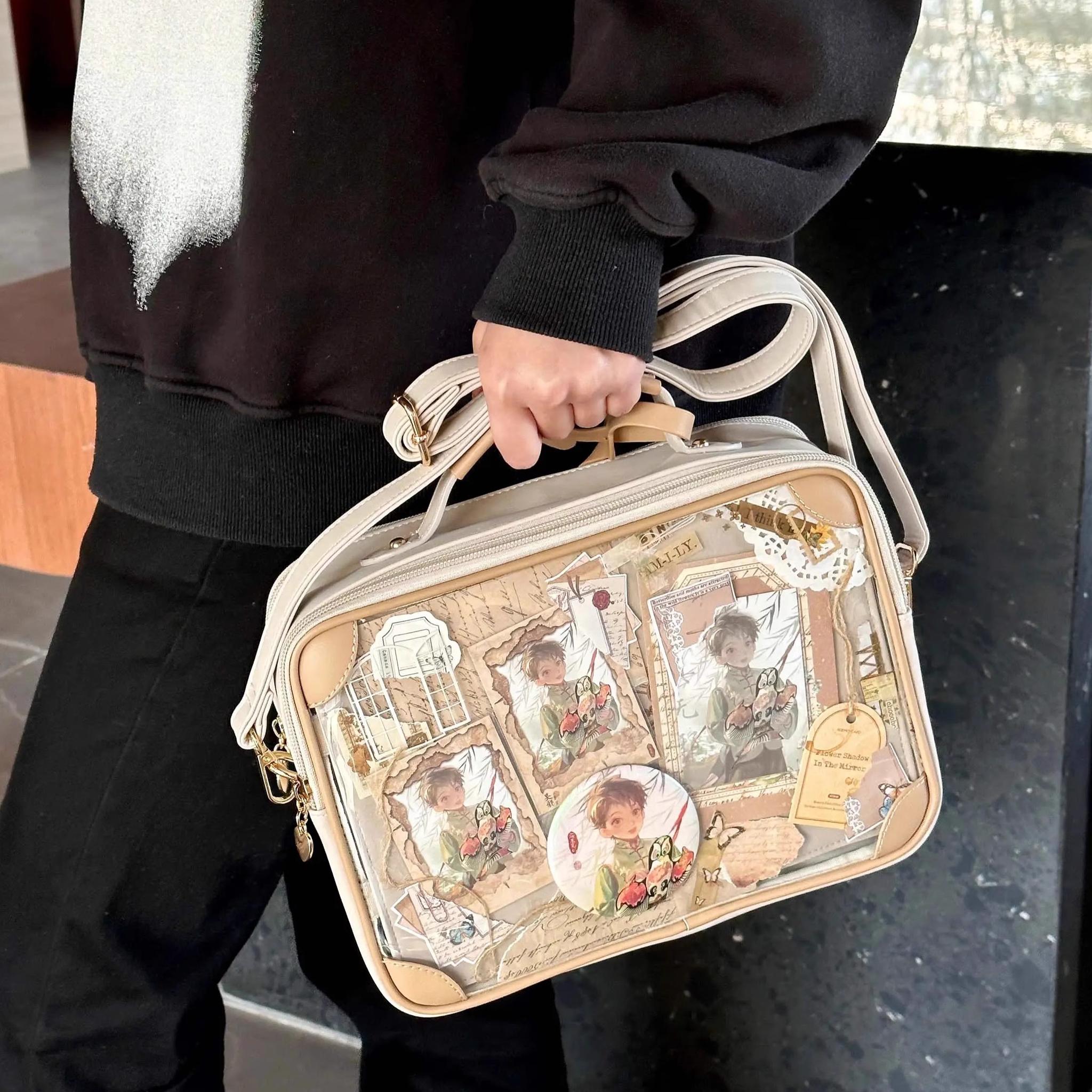 Vintage themed jirai kei itabag front three-quarter view holding top handle indoor dark space teen model transparent anime collage beige leather straps