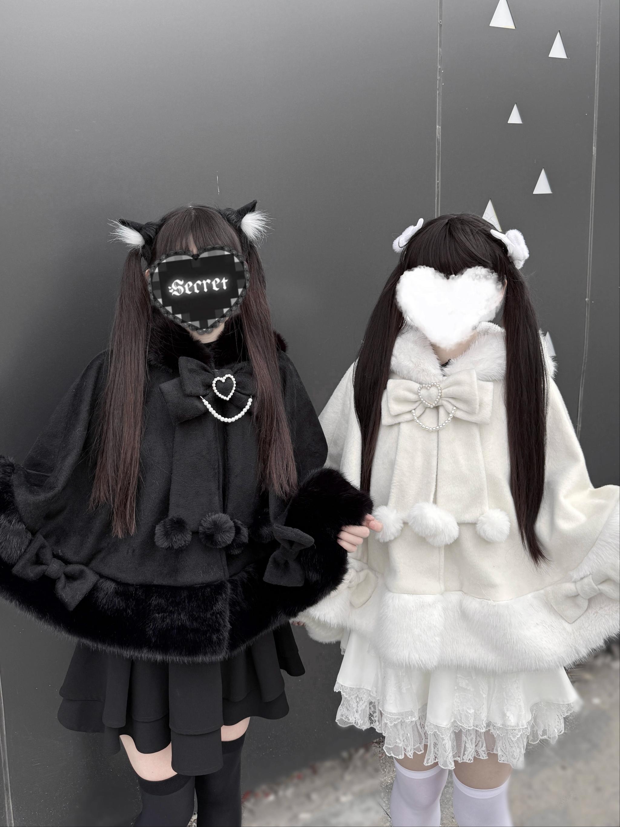 Two models wearing Jirai Kei cat ear hooded plush capes in black and ivory colors full body studio shots