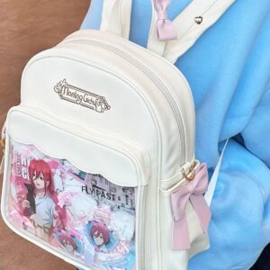 Kawaii anime itabag on human model showing embroidered vintage logo close-up smooth leather texture with side bow detail