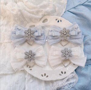 Light water blue white bow hair clips Jirai Kei aesthetic with fluffy fur lace trim and silver snowflake decoration on white plate mixed blue pink lace