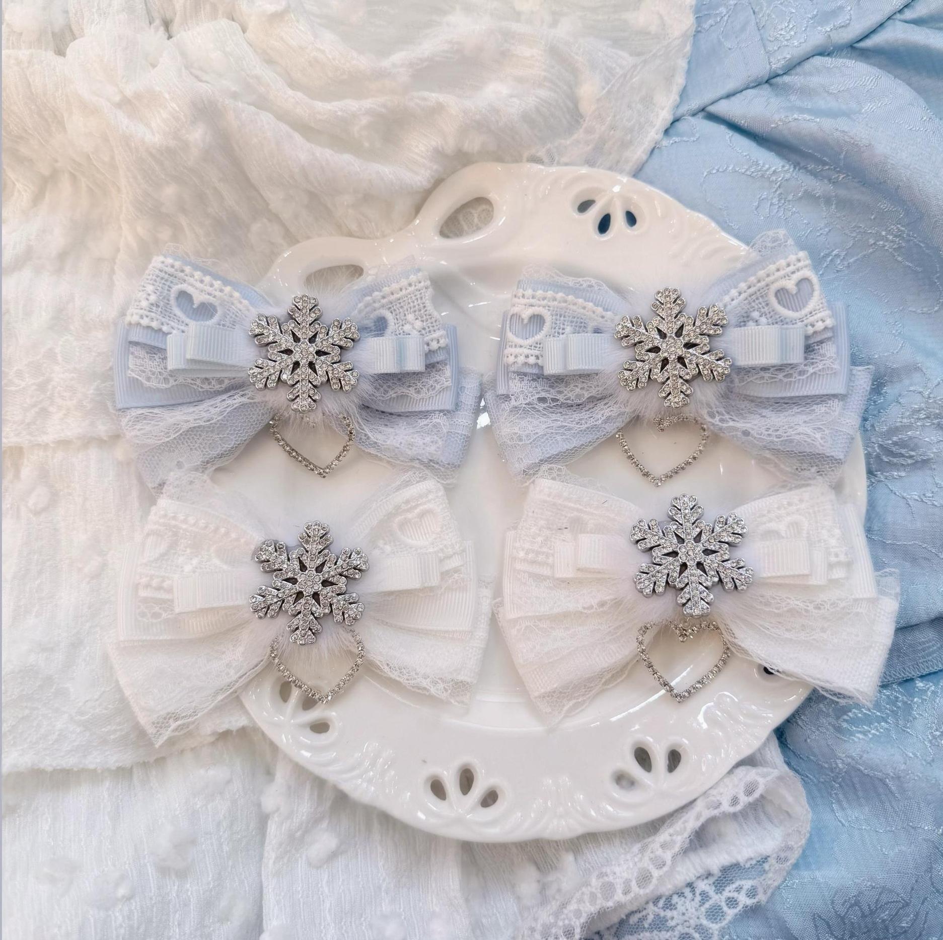 Light water blue white bow hair clips Jirai Kei aesthetic with fluffy fur lace trim and silver snowflake decoration on white plate mixed blue pink lace