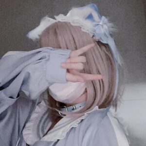 Side profile close-up of jirai kei cat ear headdress showing lace frill detail and decorative satin bow with pink-haired model