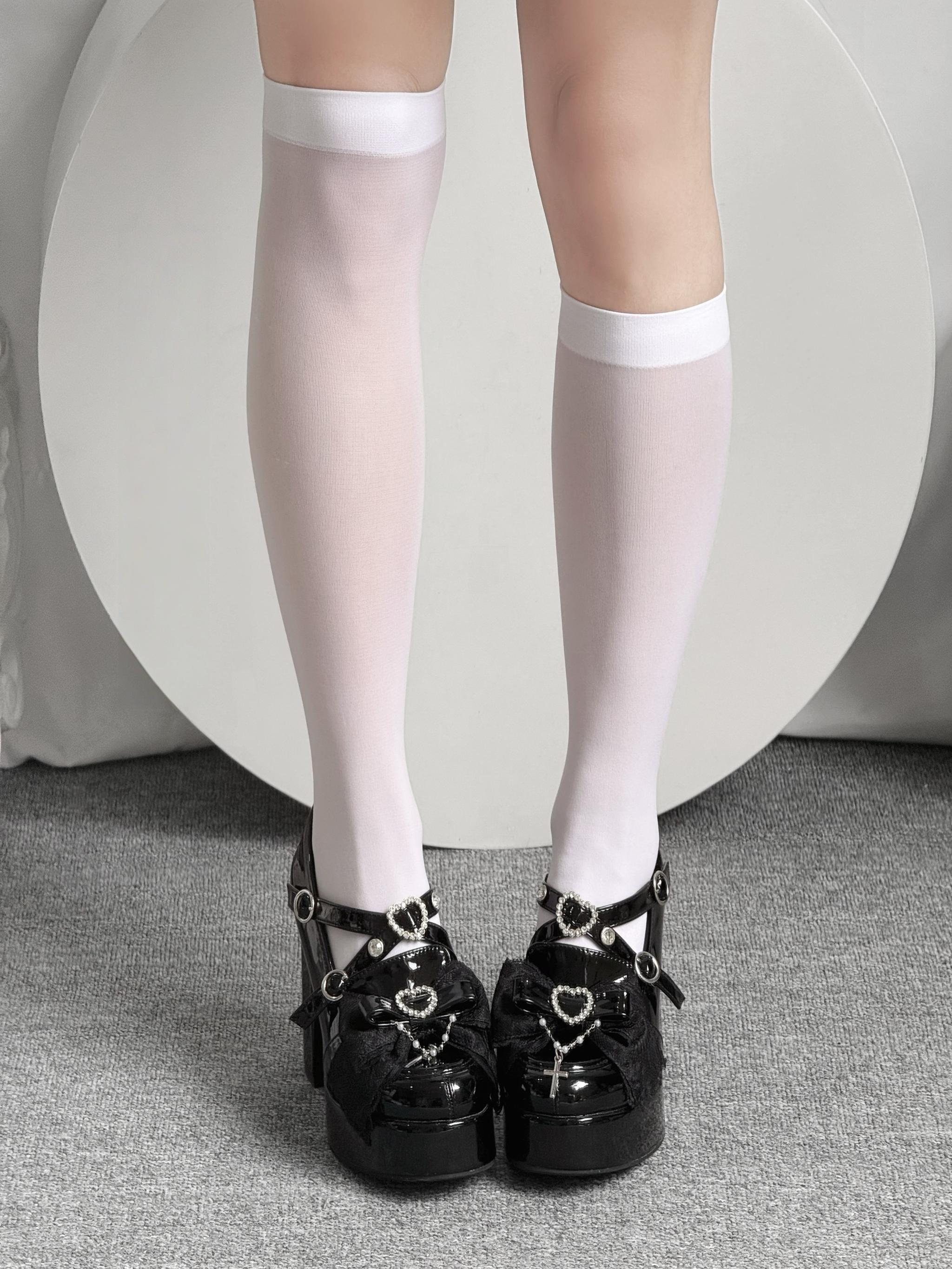 White knee-high Jirai Kei socks studio shot paired with black loafers demonstrating sweet feminine aesthetic