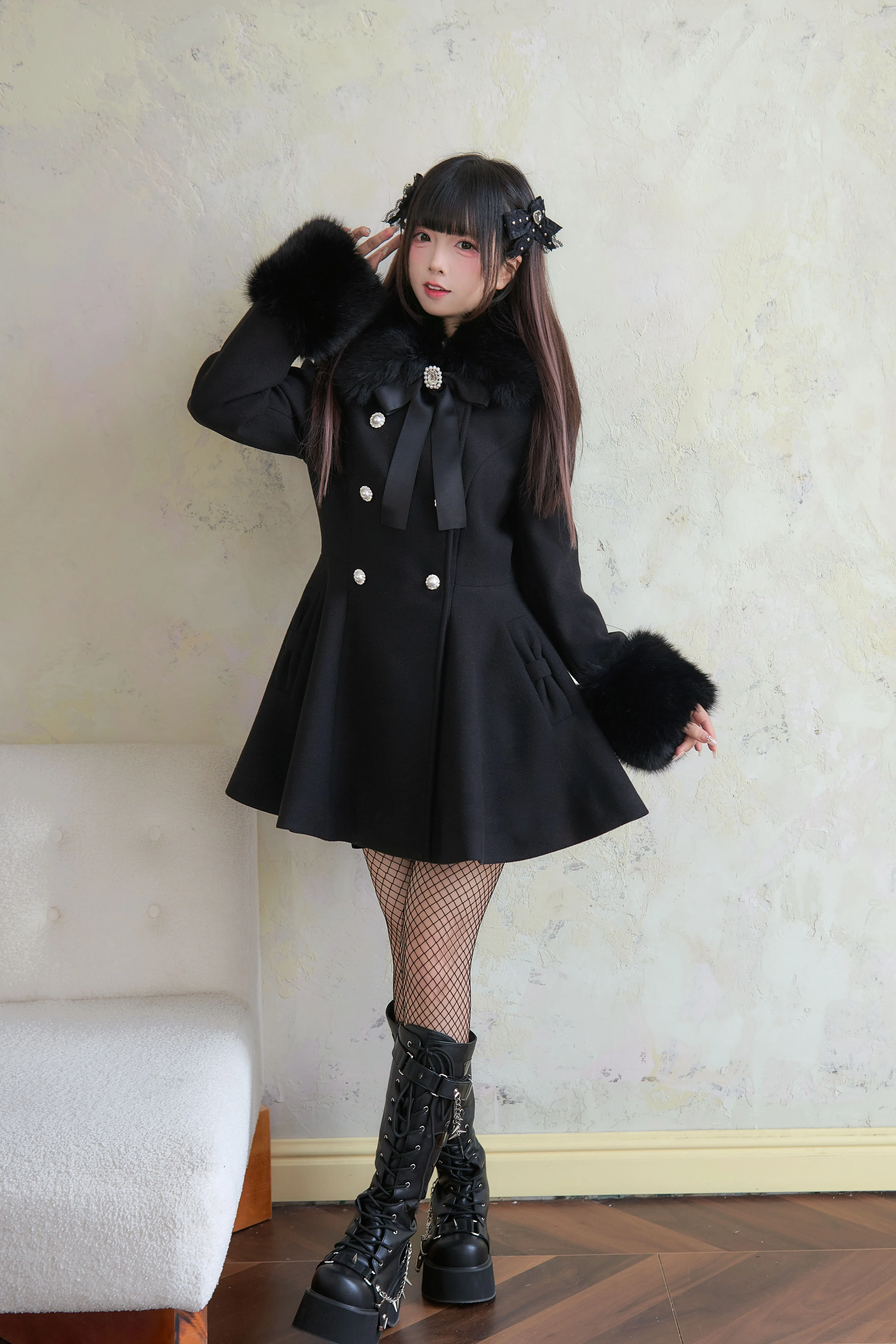 Three-quarter front view of black Jirai Kei faux fur cuffed winter coat with ribbon bow neck detail and double-breasted design