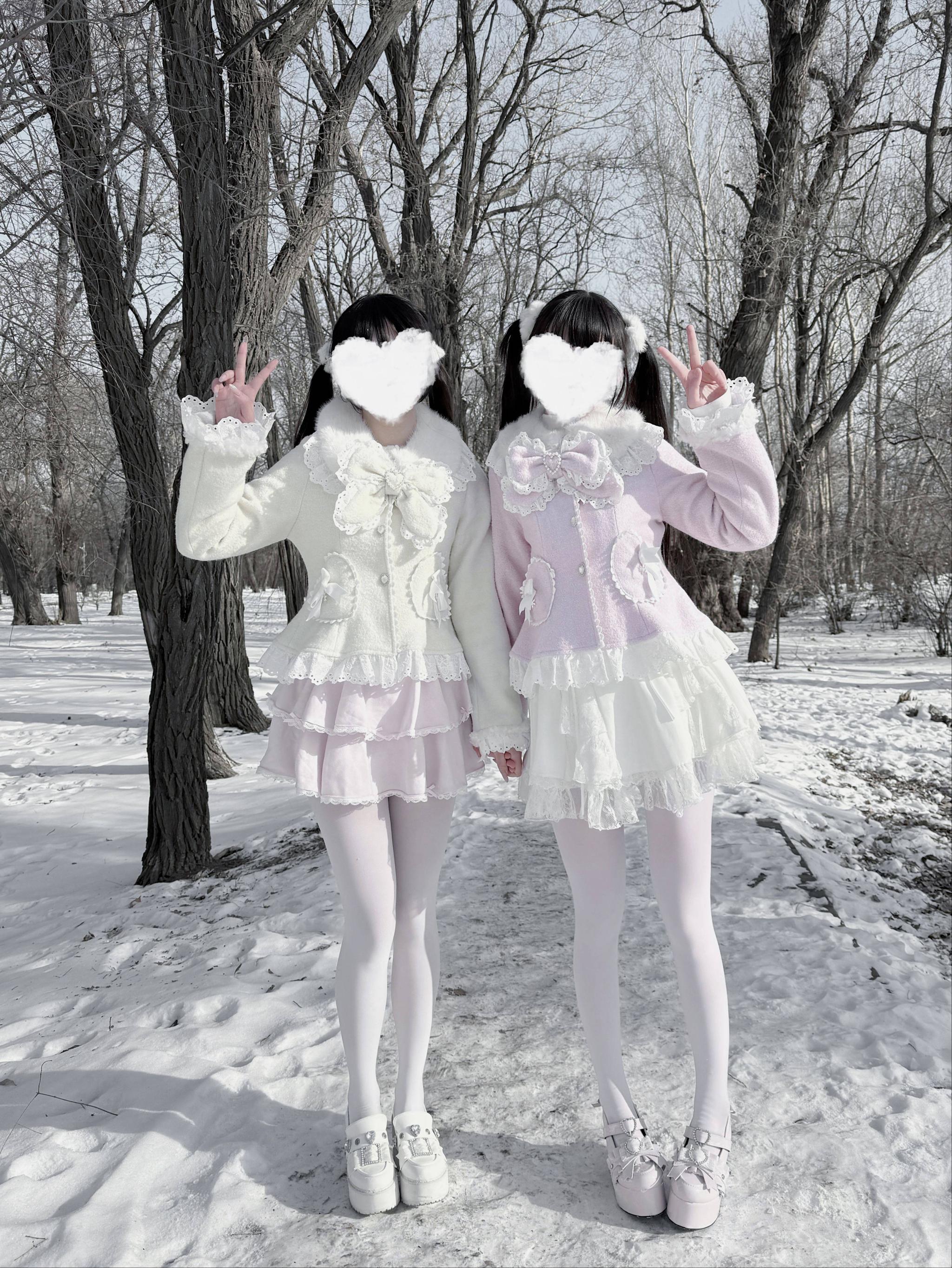 Jirai Kei Ryousangata wool coats styled on two models in pink and cream matching outfits, side three-quarter view winter outdoor snowy park setting