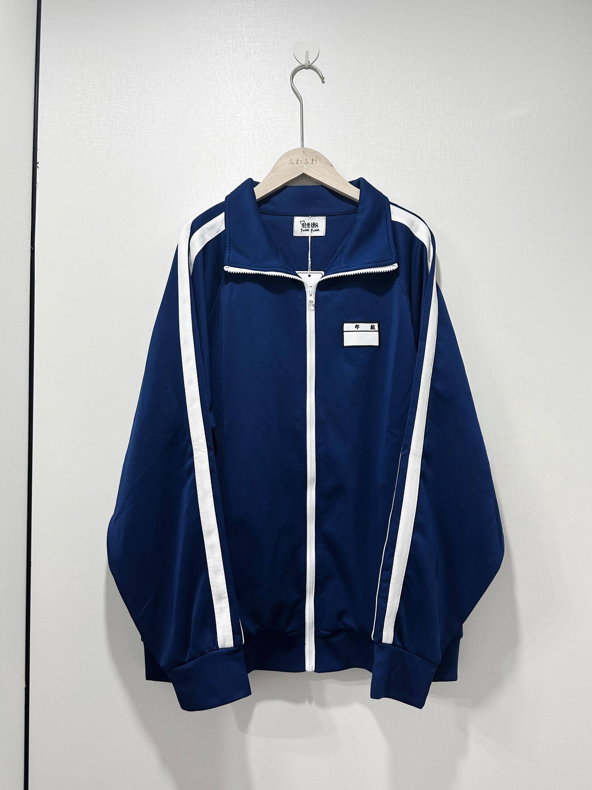Navy sports jacket with name label embroidered patch detail, featuring white stripe accents on sleeves and authentic Japanese school uniform inspired design, professional product display