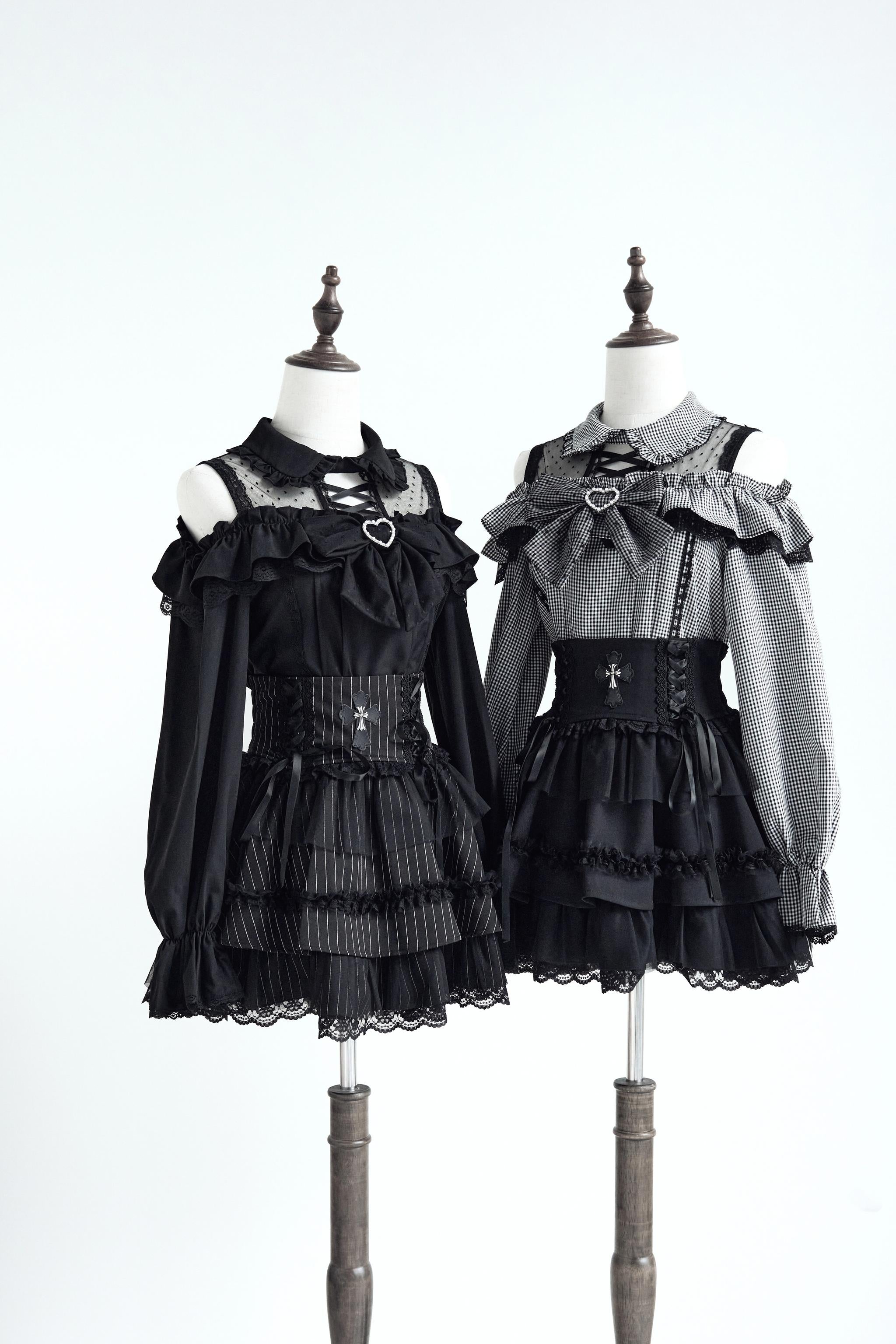 Cold-shoulder Jirai Kei blouse black and grey variants on dress forms with corset belt styling