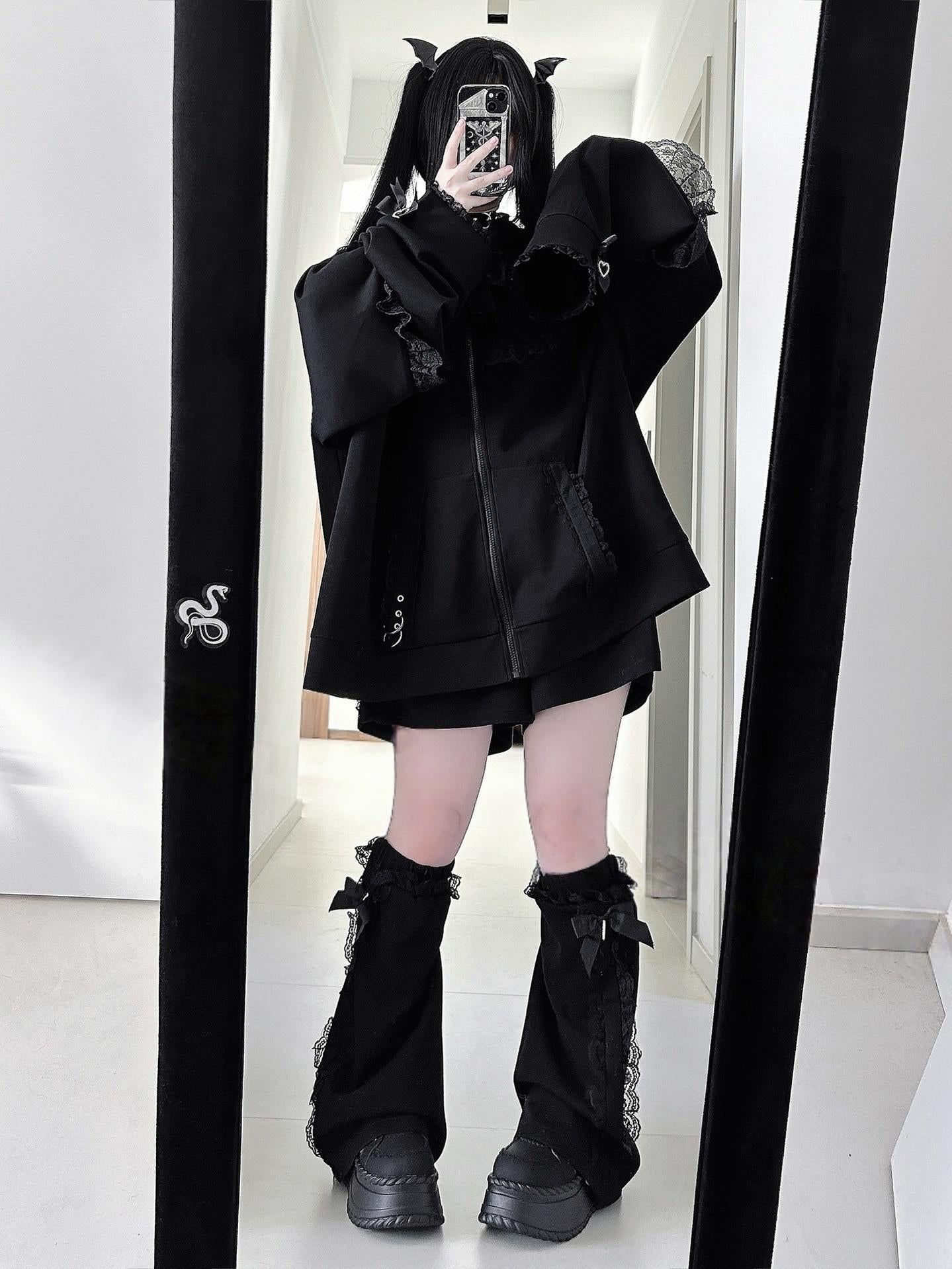 Black oversized Jirai Kei zip-up hoodie with rabbit ears and lace trims worn with matching ruffled leg warmers, full-body front mirror selfie with devil tail accessories