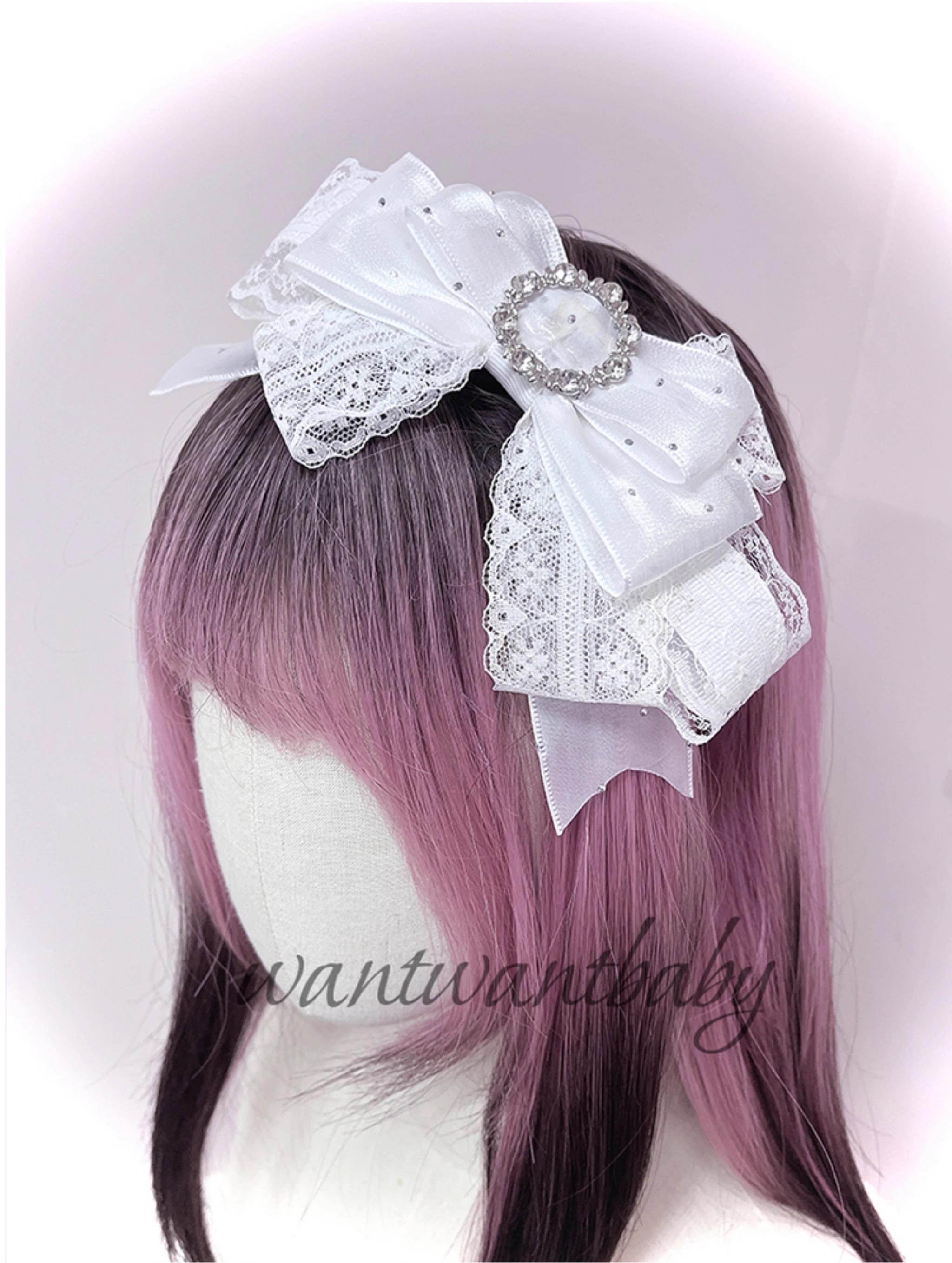 White satin rhinestone bow hair accessory with layered ribbon design and sparkling brooch on ombre mannequin head side view