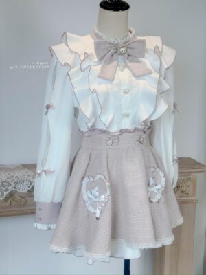 Pink and white ryousangata tweed Lolita dress on dress form mannequin, displaying detachable bow collar, structured silhouette, high-waisted tweed skirt, and overall coordinate design