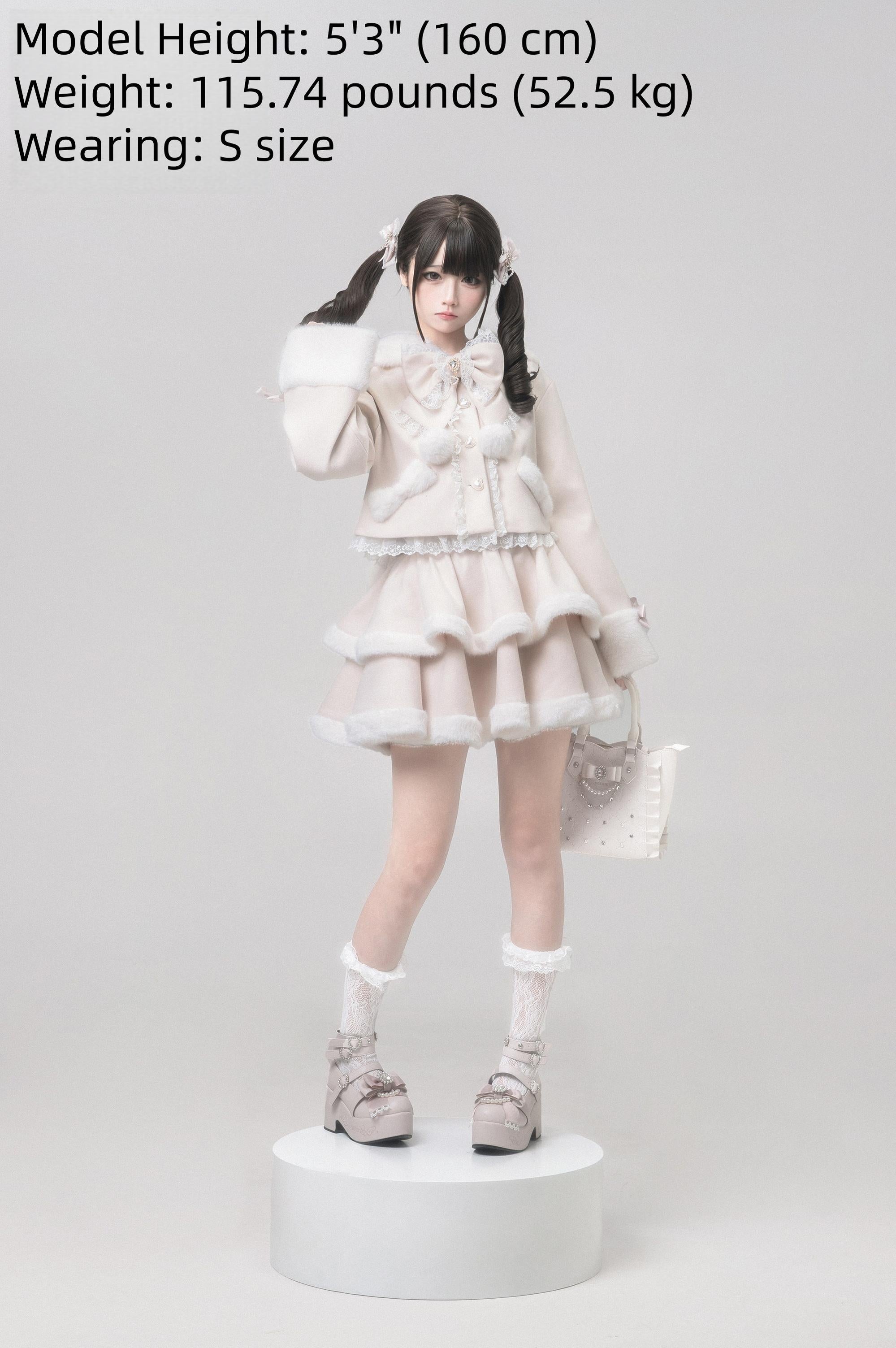 Ryousangata Jirai Kei outfit with matching studded handbag and platform loafers, lace socks, beige winter coat and tiered skirt full coordinate standing on display plinth