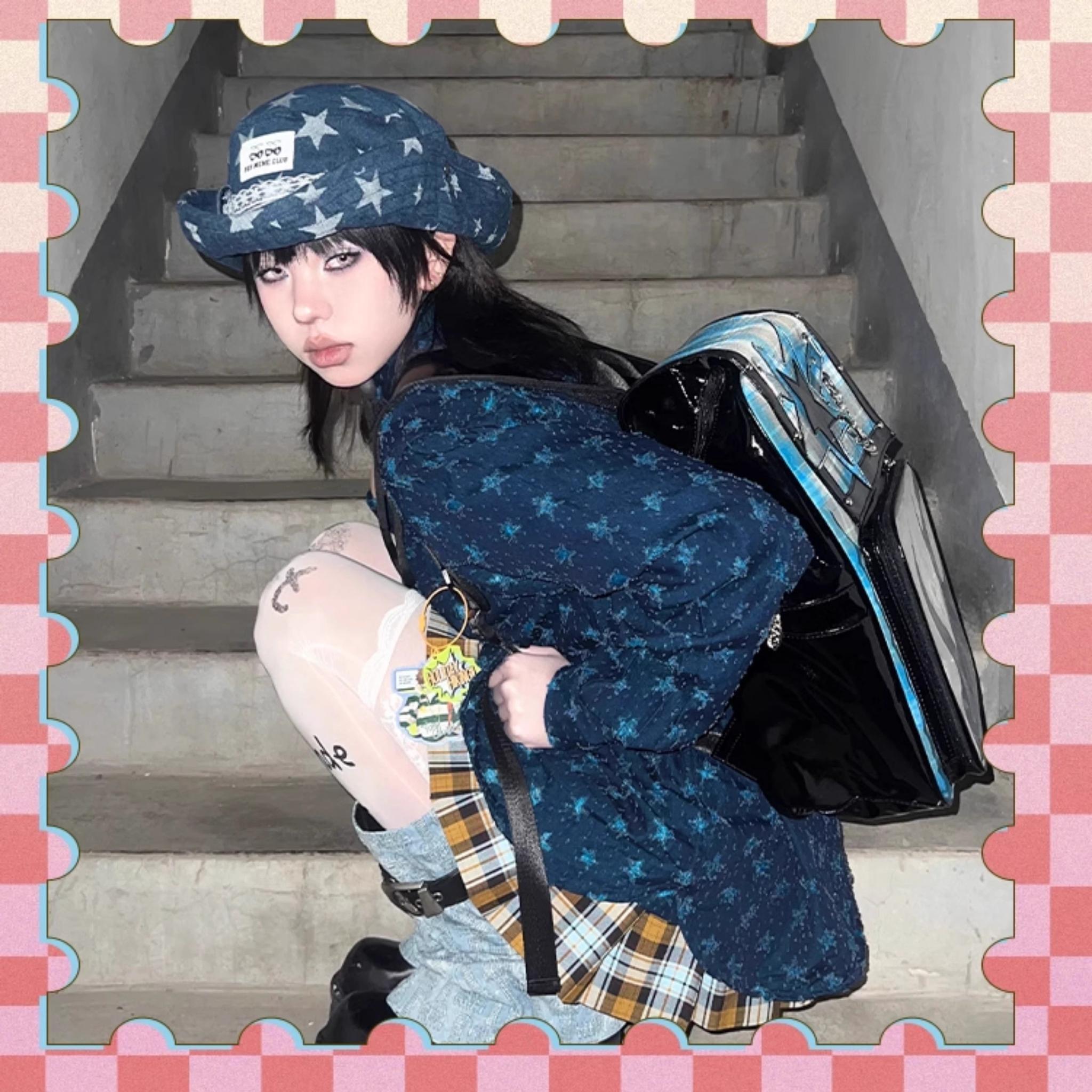 Plaid star ita backpack exterior pocket detail with metal chain accent and magnetic flap closure system