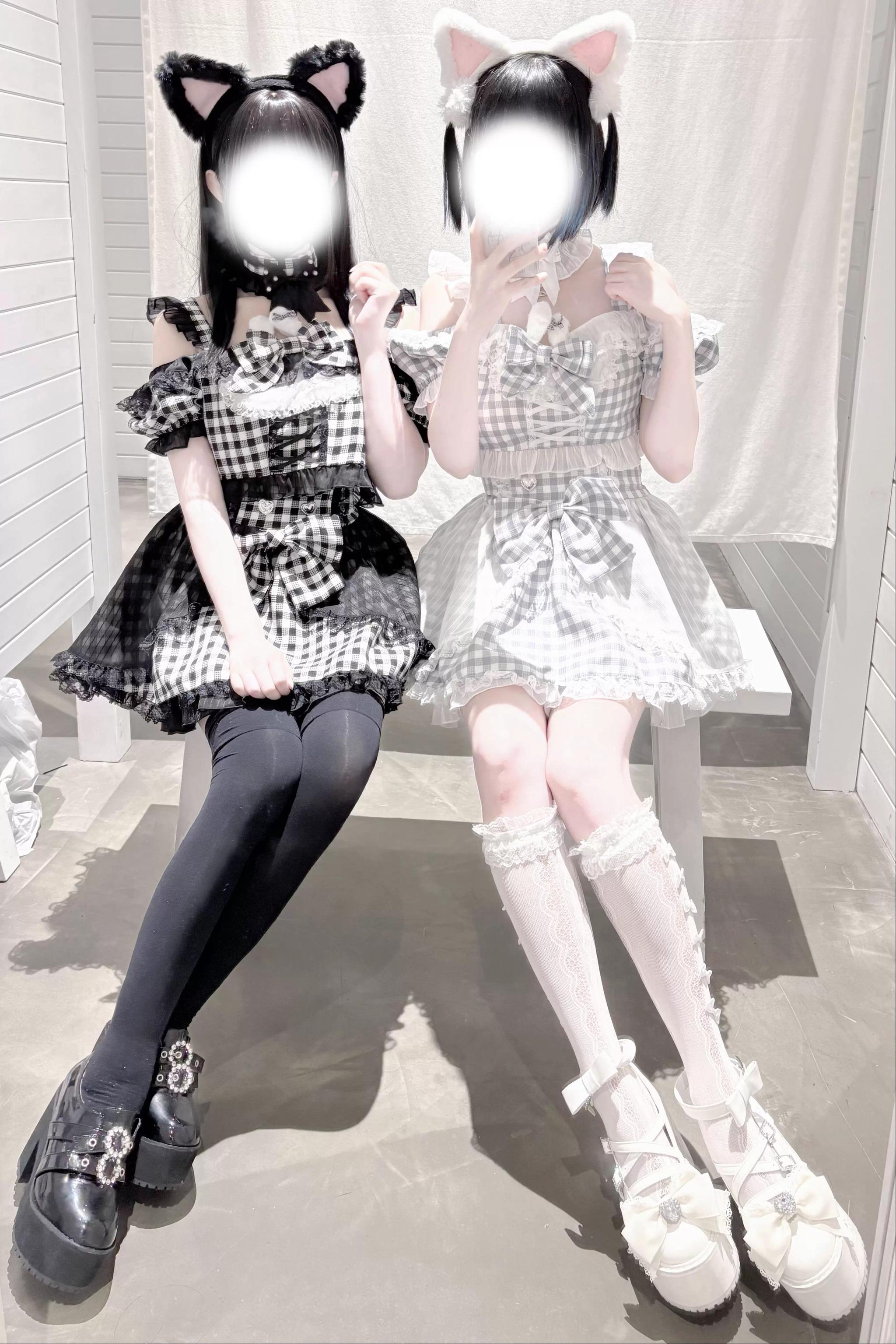Front full body shot of gingham plaid jirai kei maid outfit on outdoor bench with layered lace skirt trim and platform footwear