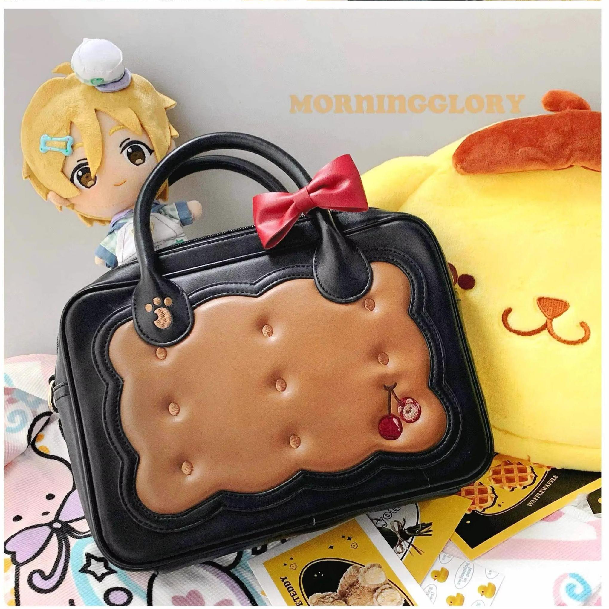 Black cherry bear cookie Jirai Kei crossbody bag with cookie-shaped front panel cherry embroidery red bow accent merchandise display