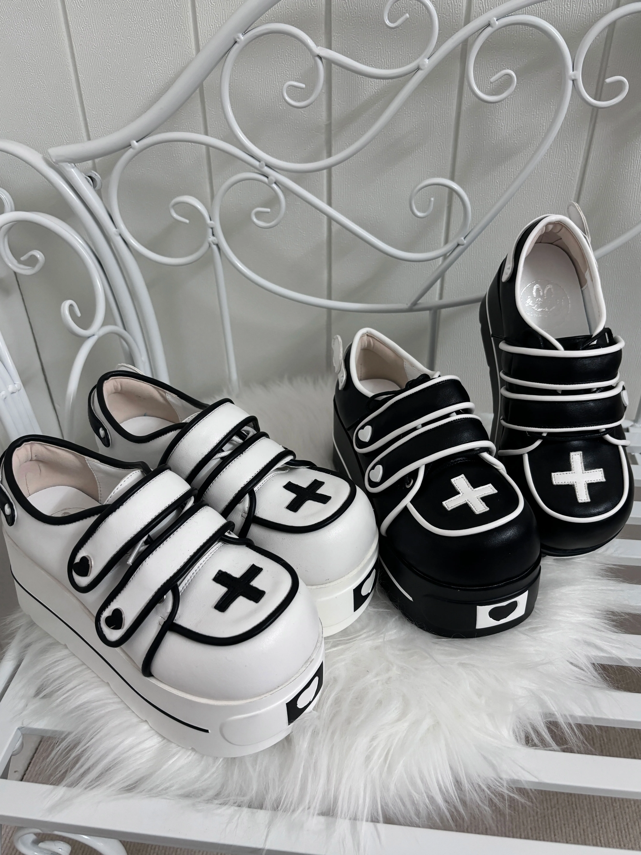 Tenshi angel heart platform shoes two colorway variants displayed on white furry bed hook and loop straps rounded sole detail