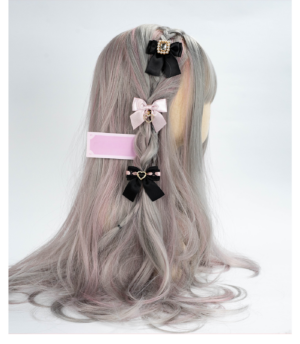 Black and light pink Jirai Kei bow hair clips with rhinestone embellishments on wig mannequin back view
