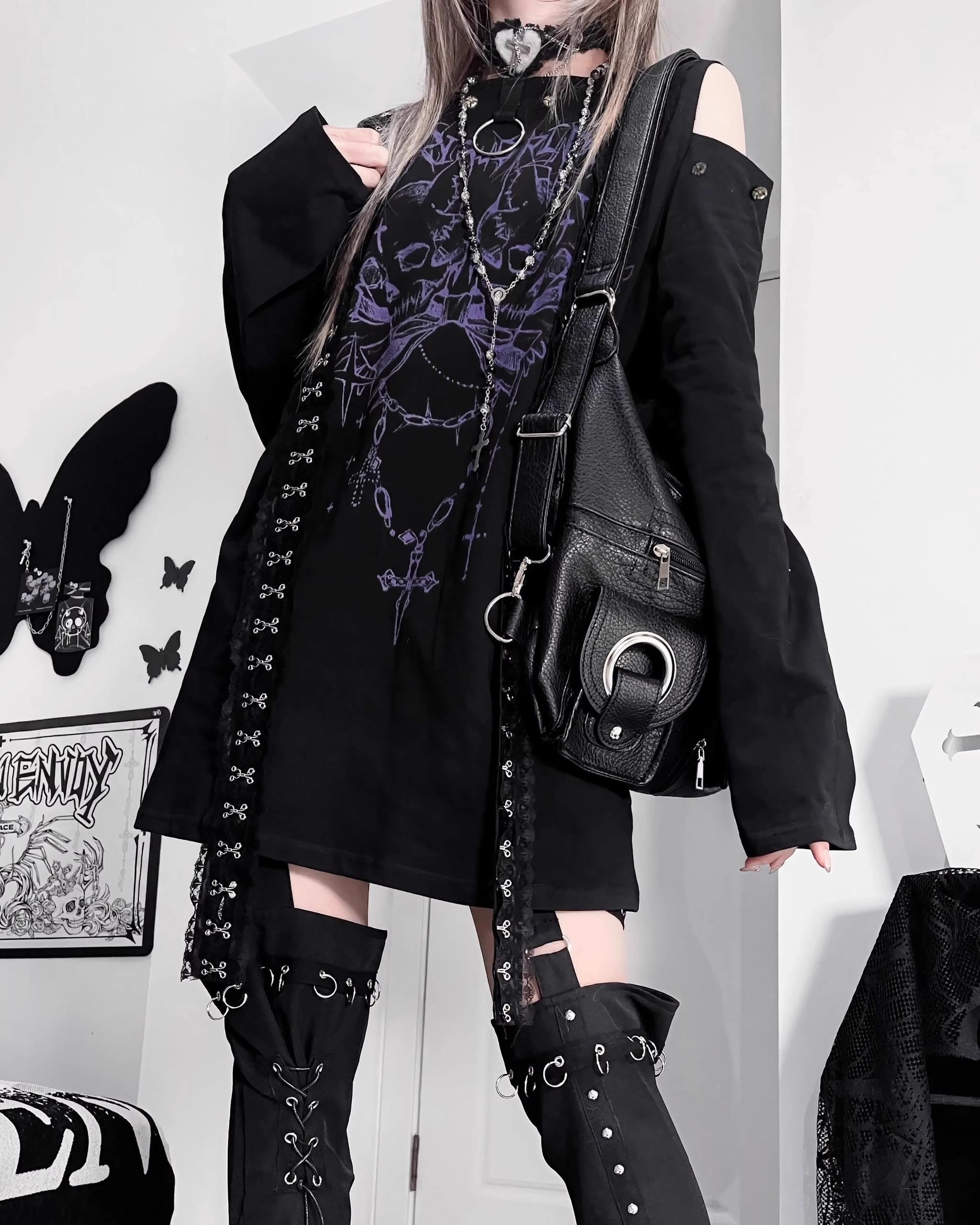 Black cold-shoulder gothic t-shirt with purple skull graphic and cross strap trims front 3/4 close-up detail