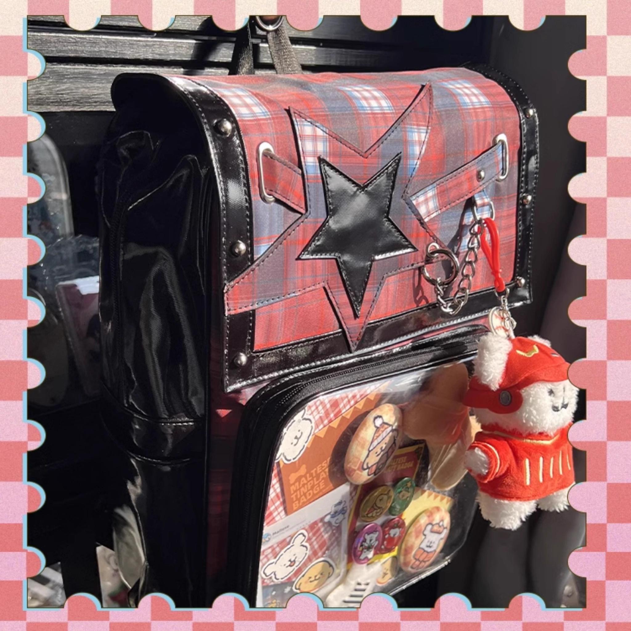 Plaid star ita backpack three-quarter angle showing clear display window transparency and badge arrangement
