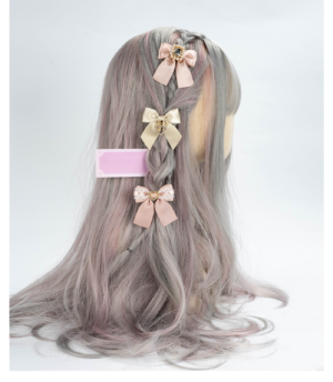 Jirai Kei rhinestone bow hair clips displayed on mannequin head with curly grey wig showing rear view with pink and beige tones