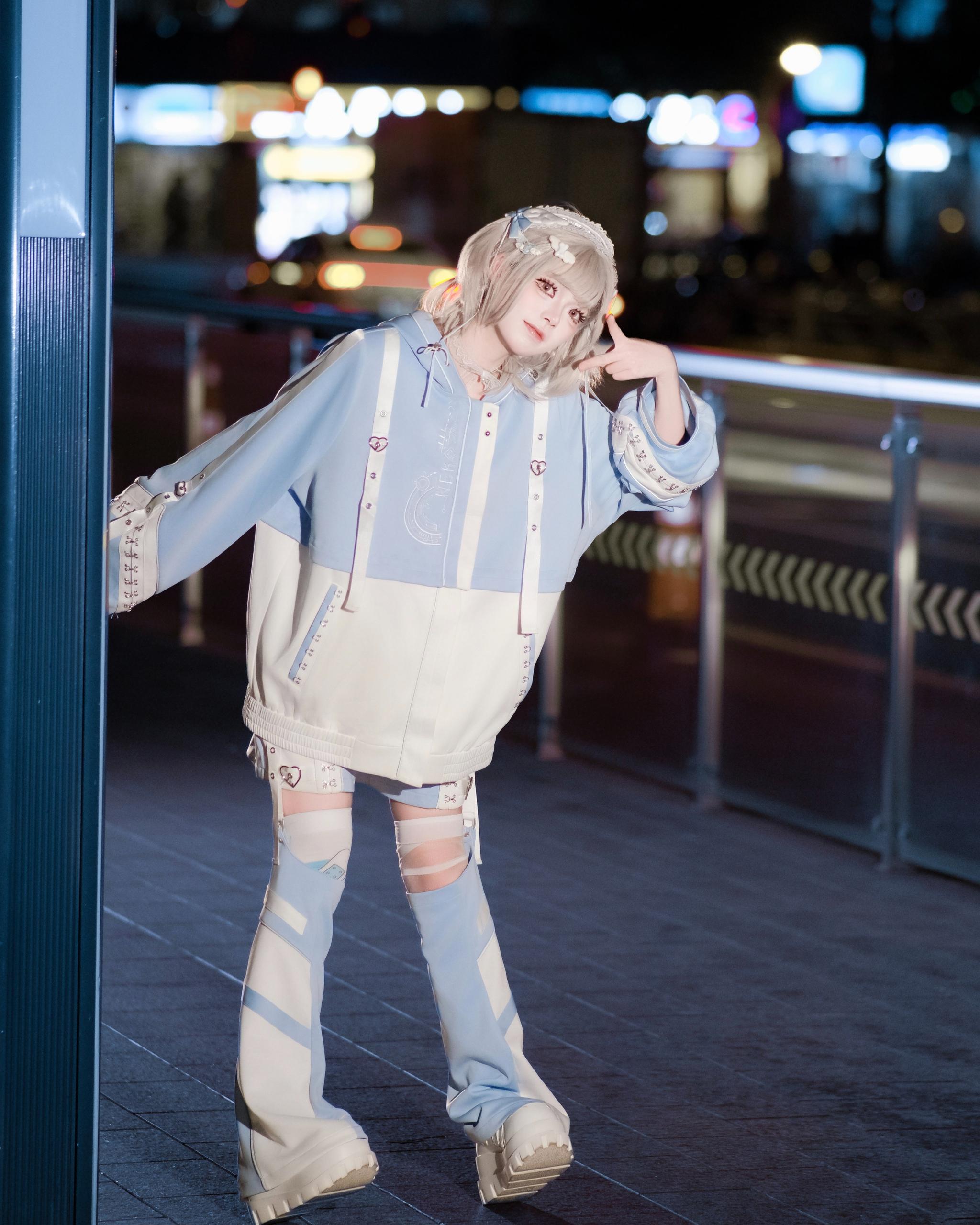 Light blue techwear hoodie set single model side full body night view outdoor overpass city lighting oversized cropped hoodie