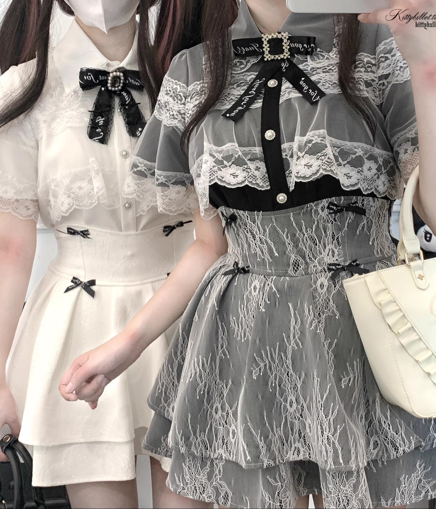 Two female models in upper body close-up wearing lace-trimmed romantic tops with matching double-layered jirai kei skirts featuring black bow accents throughout