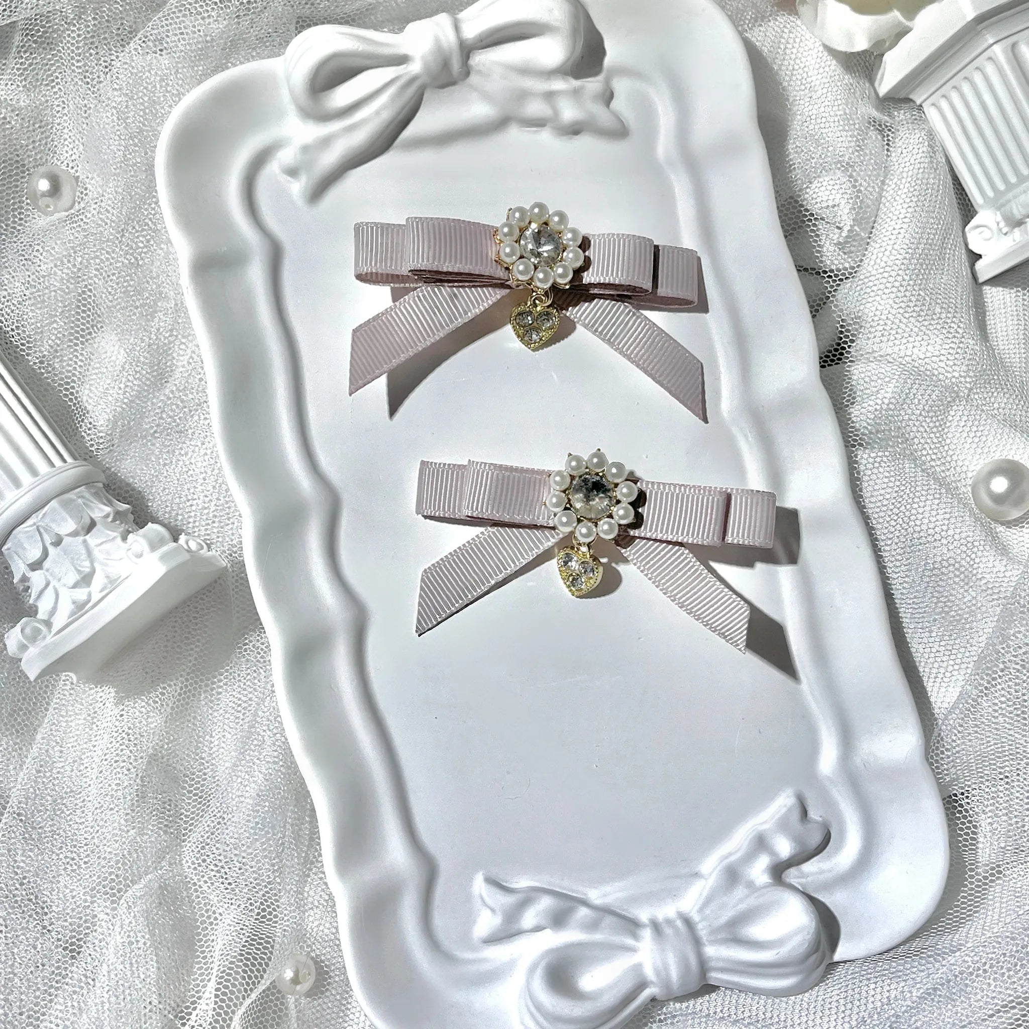 Dusty pink bow pendant hair clips Jirai Kei aesthetic featuring romantic hanging pendant design with rhinestone pearl accents