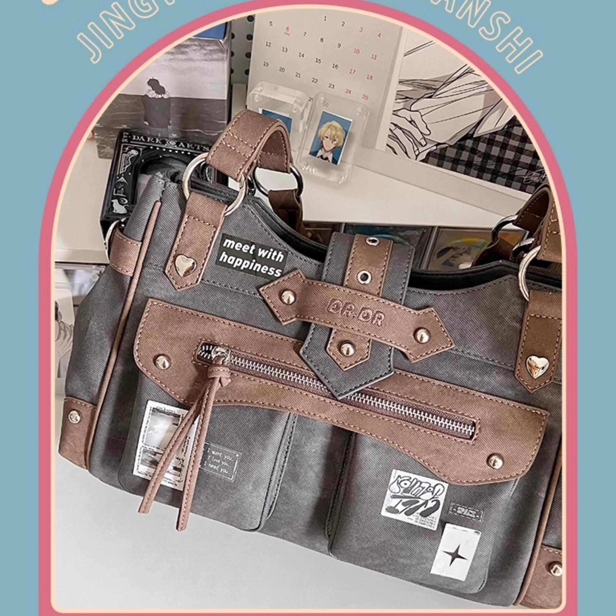 Side oblique view of Jirai Kei ita shoulder bag featuring heart-shaped metal studs, branded patches, zippered pocket details, shown in arched frame indoor background highlighting bag construction