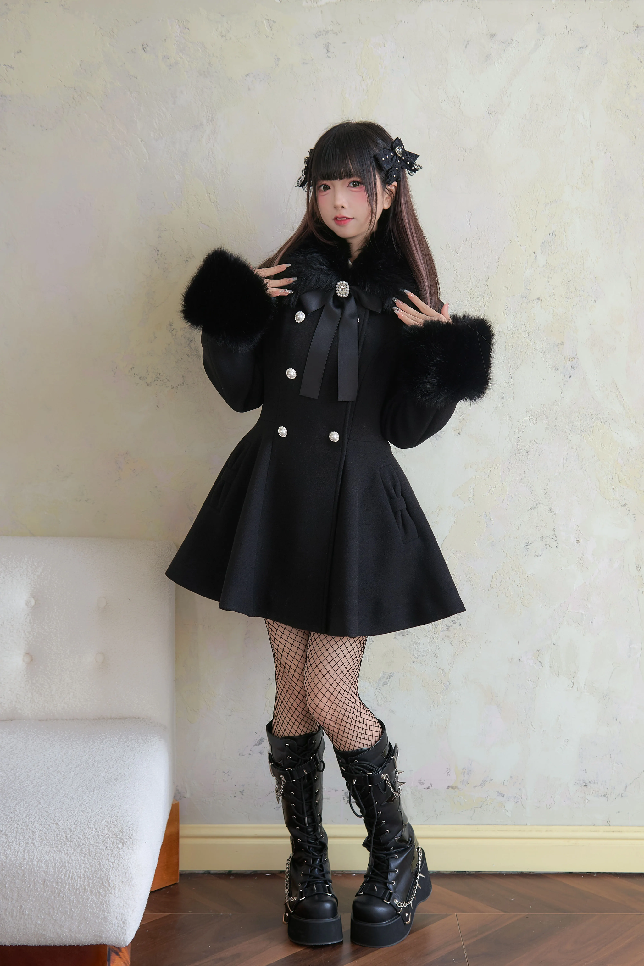 Black Jirai Kei faux fur collar winter coat front view on model showcasing cinched waist silhouette and flared hem detail