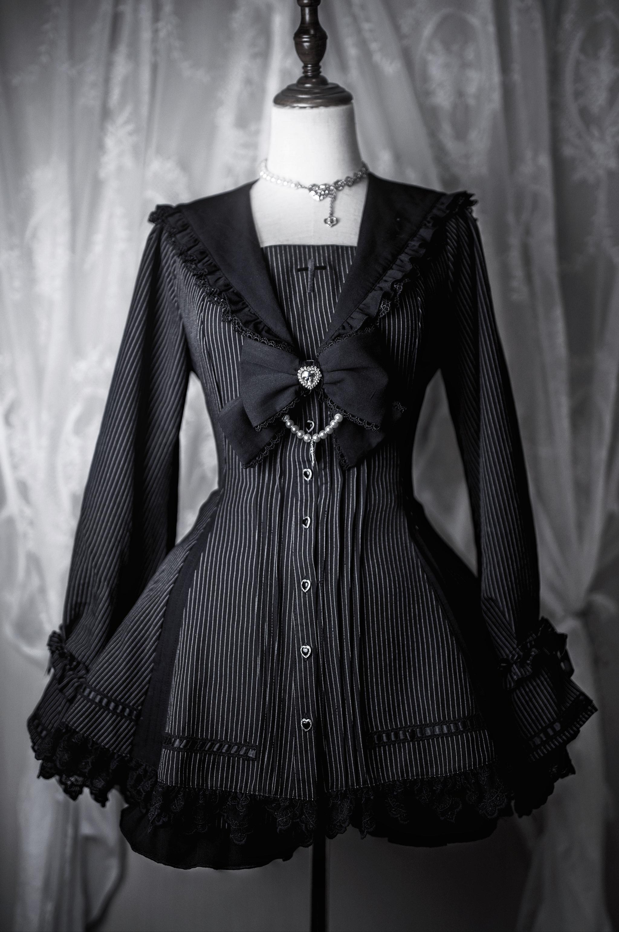 Black pinstripe gothic lolita Jirai Kei dress with large black front bow adorned with gems, fitted waist with lace-up back, and ruffled lace hem on mannequin