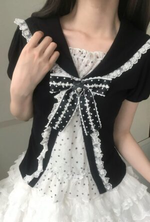 Black and white sailor collar Jirai Kei blouse with lace trim and detachable polka dot bow close-up on size S model