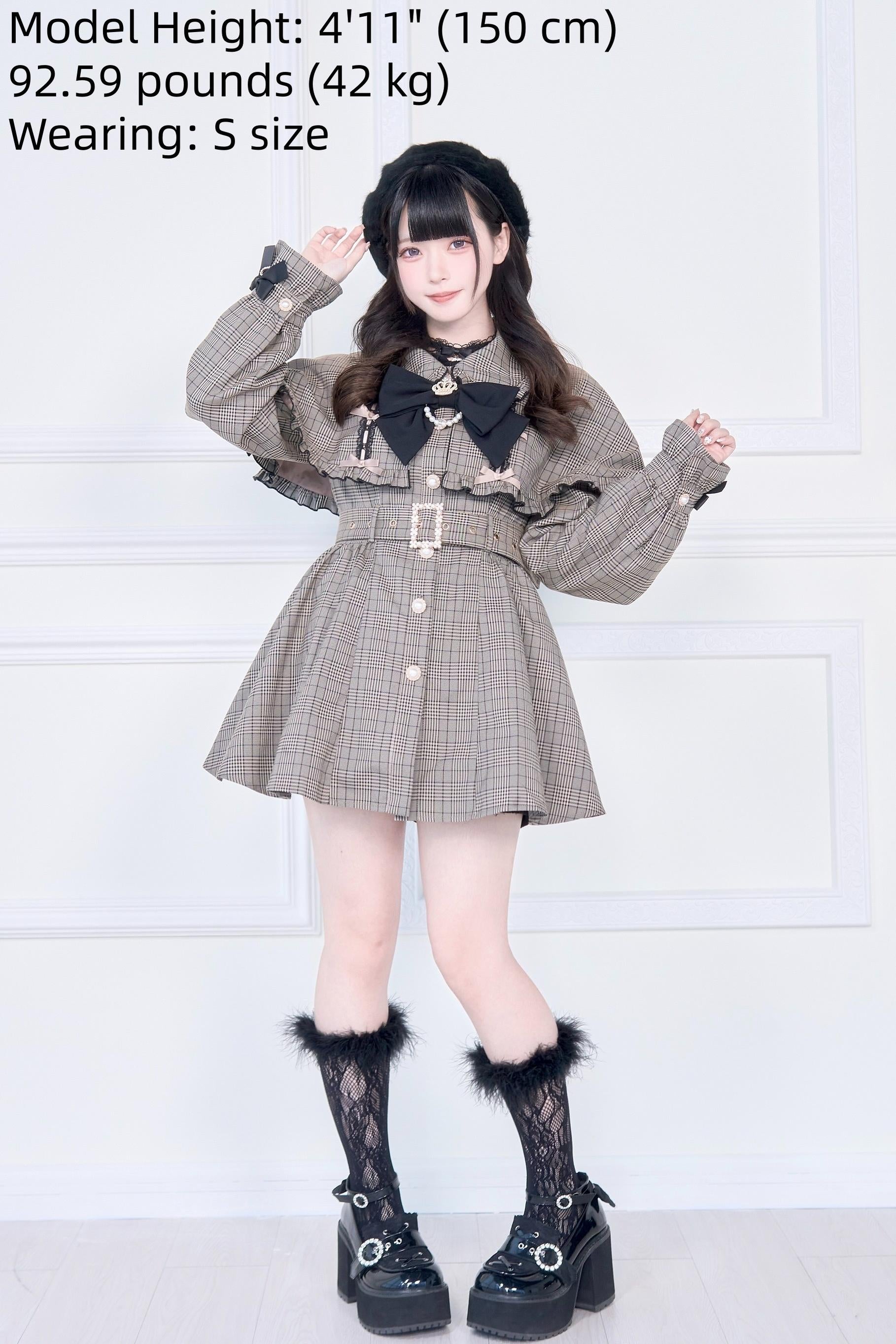 Brown plaid Jirai Kei cape trench coat front detail view showcasing black detachable bow collar and metal belt buckle