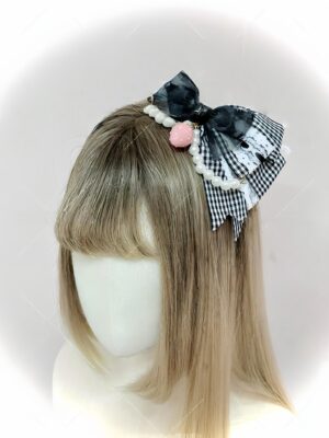 Black and white gingham bow hair accessory with sheer bow and pearl chain detail on blonde wig mannequin