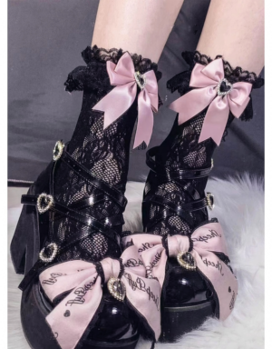 Close-up of black jirai kei lace ankle socks with heart-shaped rhinestones and pink satin bows worn with platform shoes on soft fur rug background