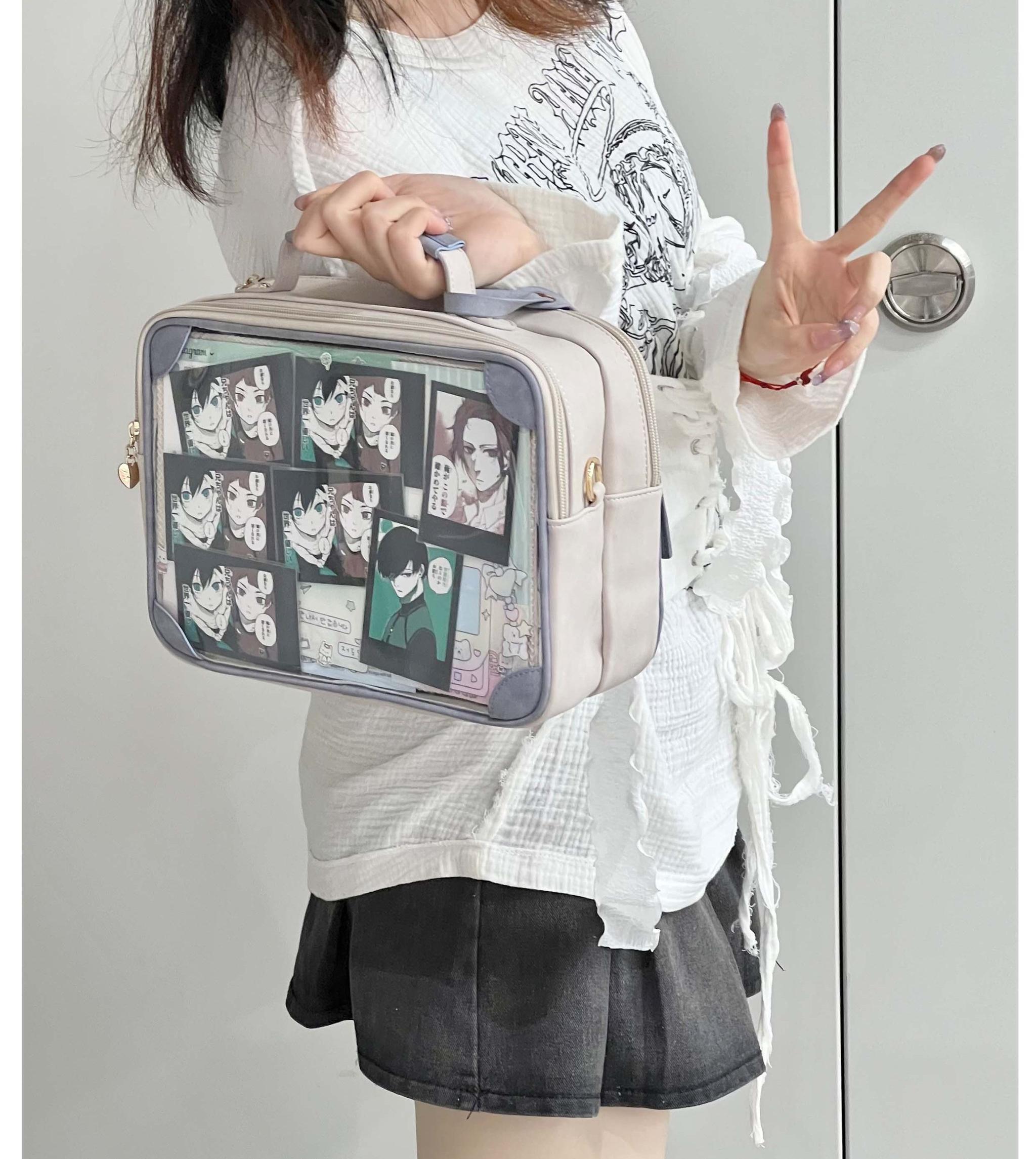 Jirai Kei itabag crossbody shoulder bag front three-quarter view worn by model indoors doorway transparent anime character display panel beige brown leather trim