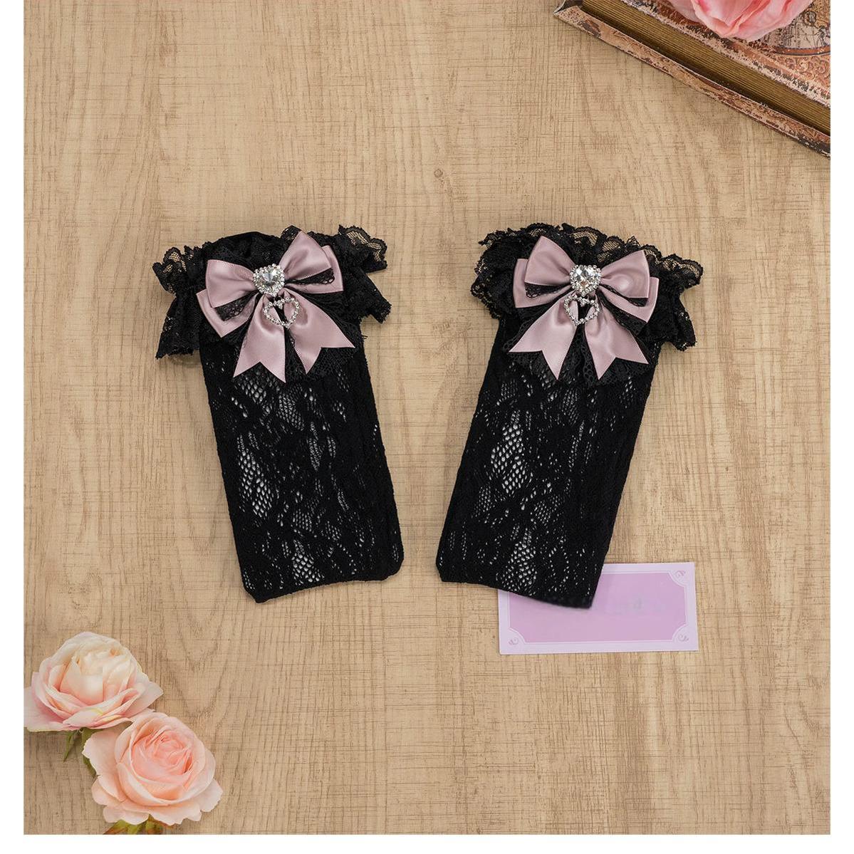 Black-blue lace knee-high Jirai Kei socks with ruffled lace cuff, blue bow and heart rhinestone detail, full length front mannequin view