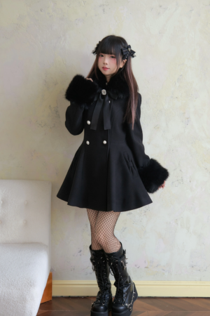 Black mid-length Jirai Kei winter coat side-front angle displaying A-line flared skirt hem and double-breasted pearl buttons
