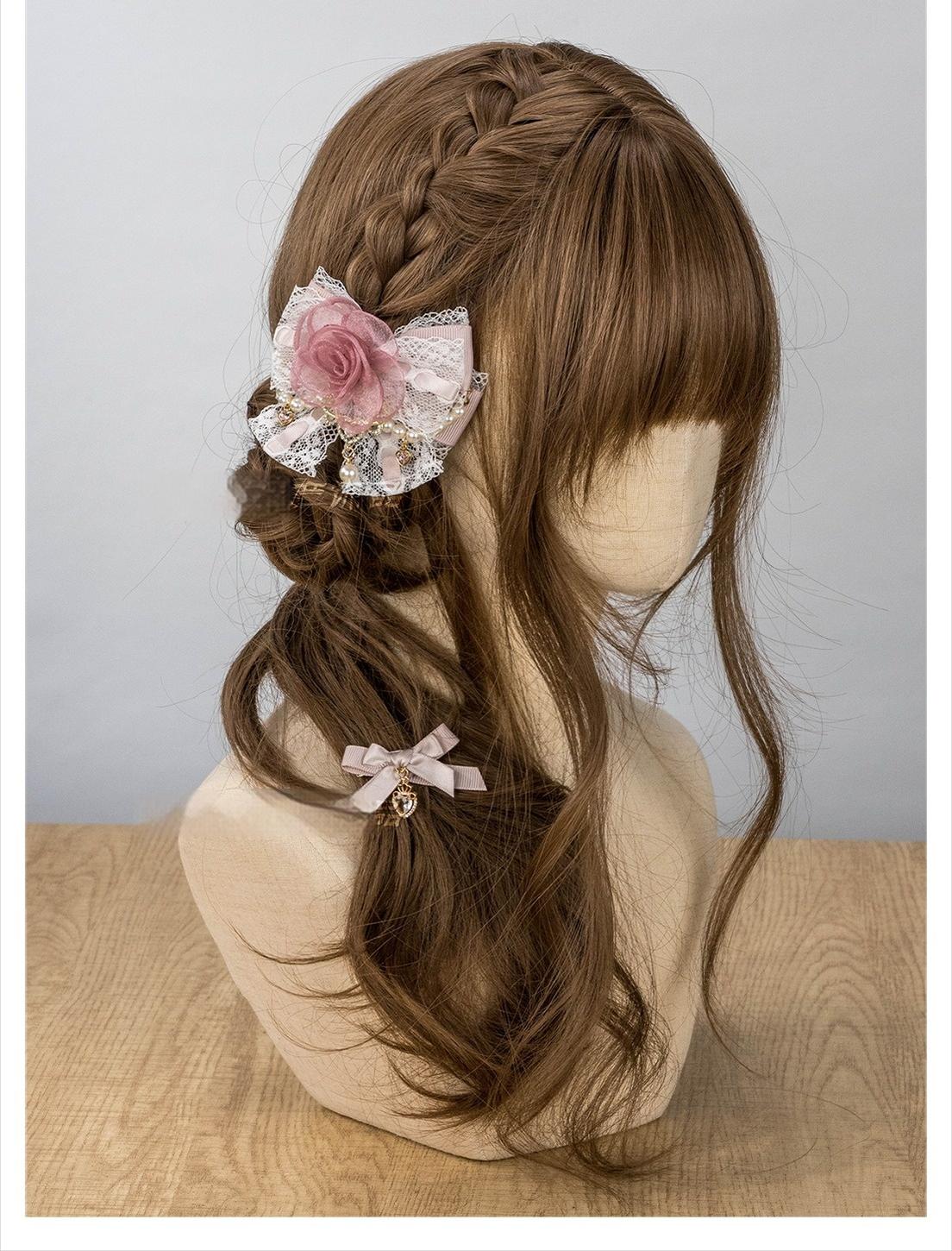 Pink Jirai Kei rose hair clip with organza rose lace bow and pearl accents on mannequin braided hair side view