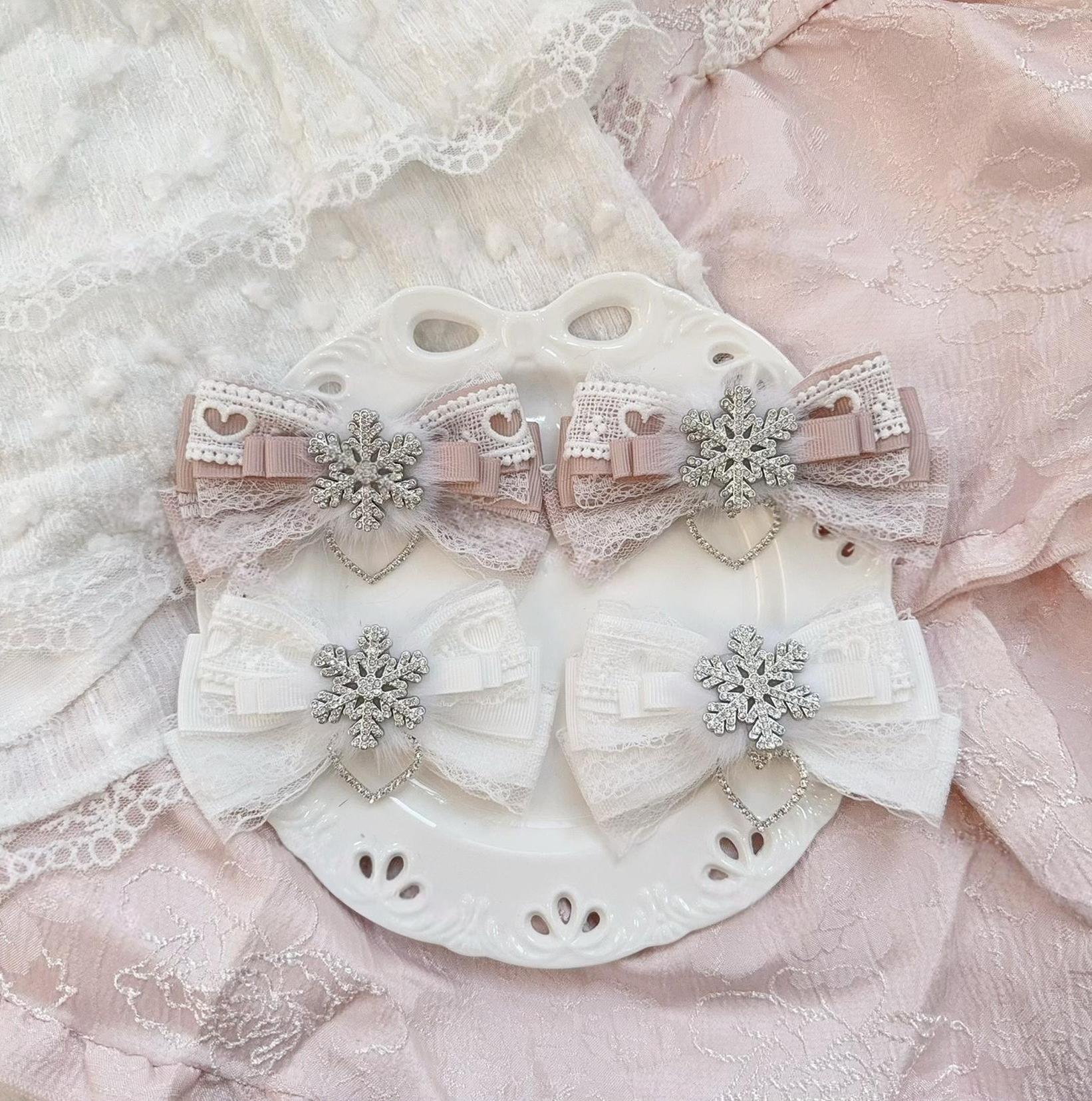 Pink and white Jirai Kei bow hair clips with heart lace cut-out silver snowflake pendant on decorative plate romantic aesthetic flat lay