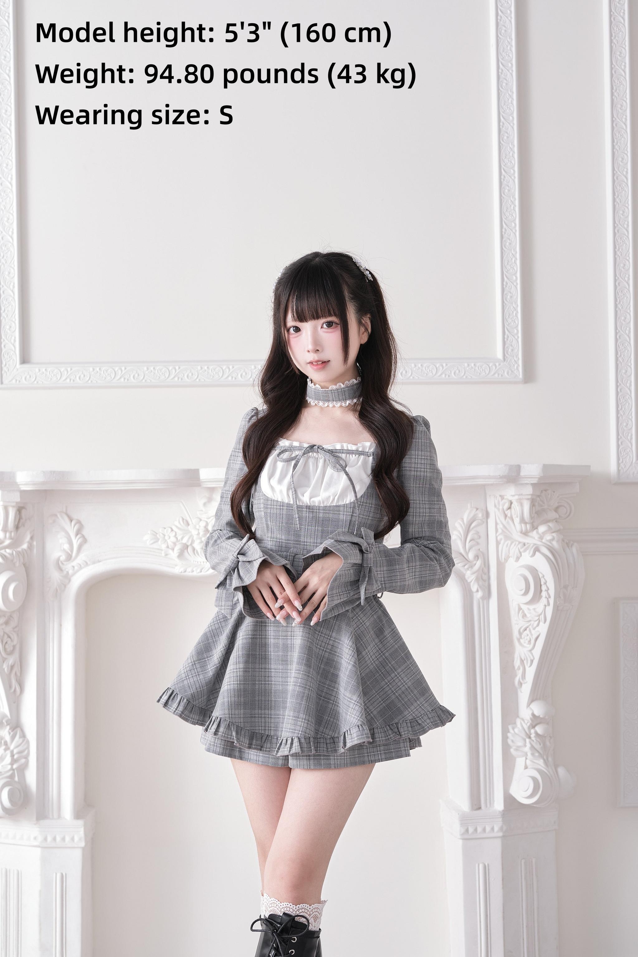 Gray plaid Jirai Kei dress front three-quarter view with white satin panel detail and short socks