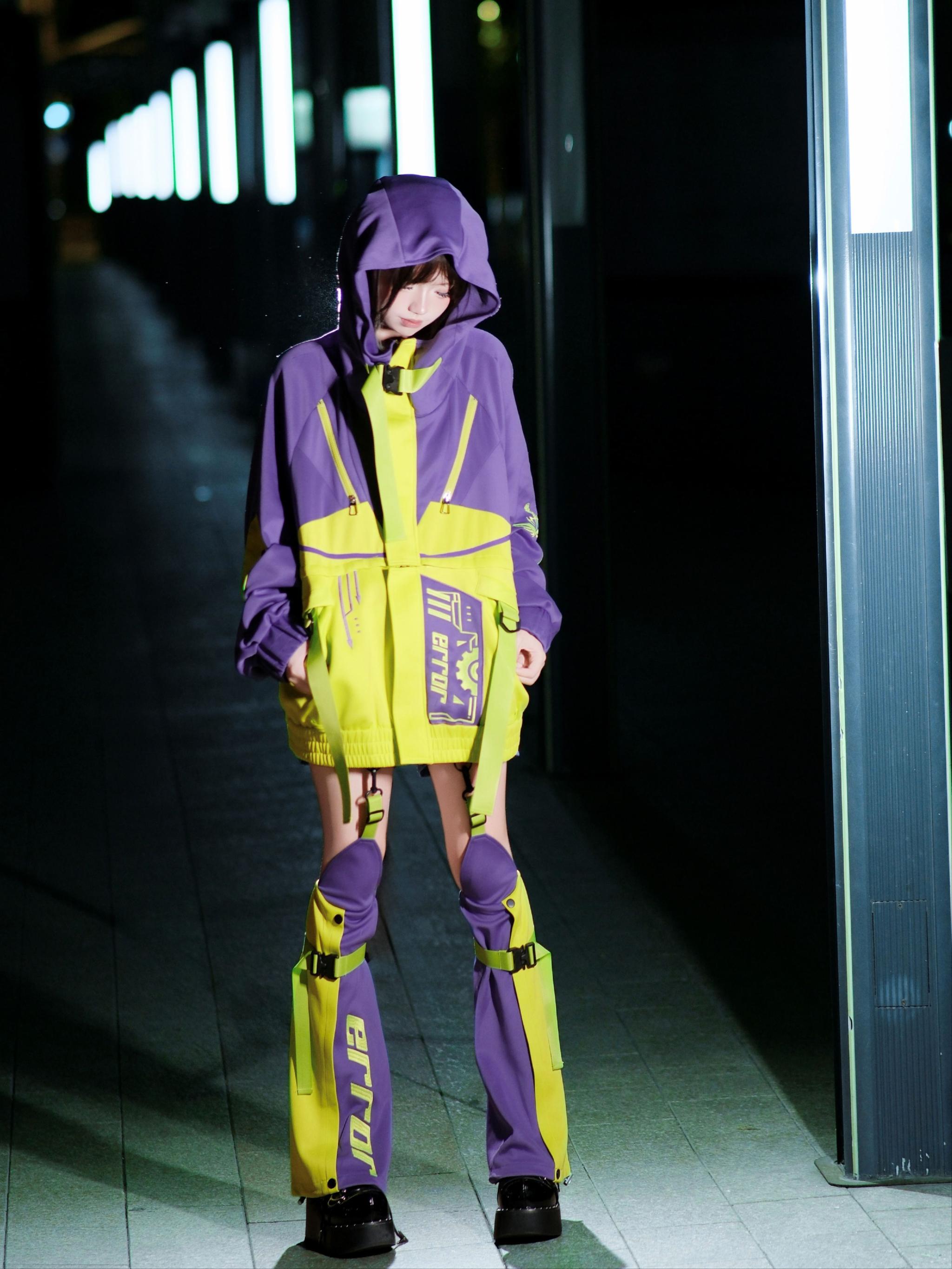 Purple yellow cyberpunk jirai kei jacket set with contrast color blocking functional patch and leg guards on hooded model night street scene