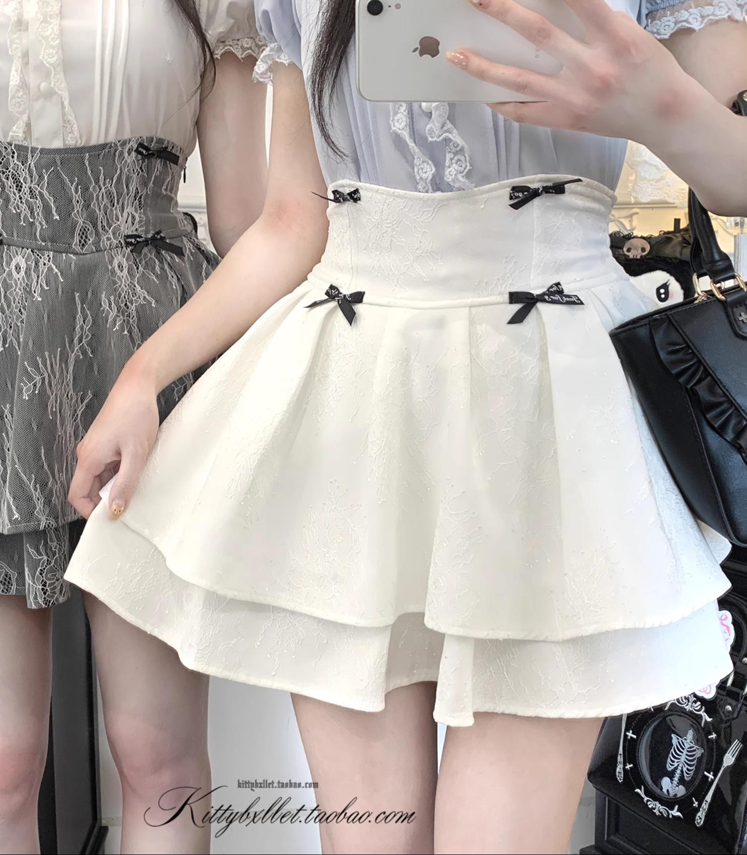 Detailed close-up of jirai kei double-layered skirt waistband, side zipper closure, and stretchy back panel construction elements on female model